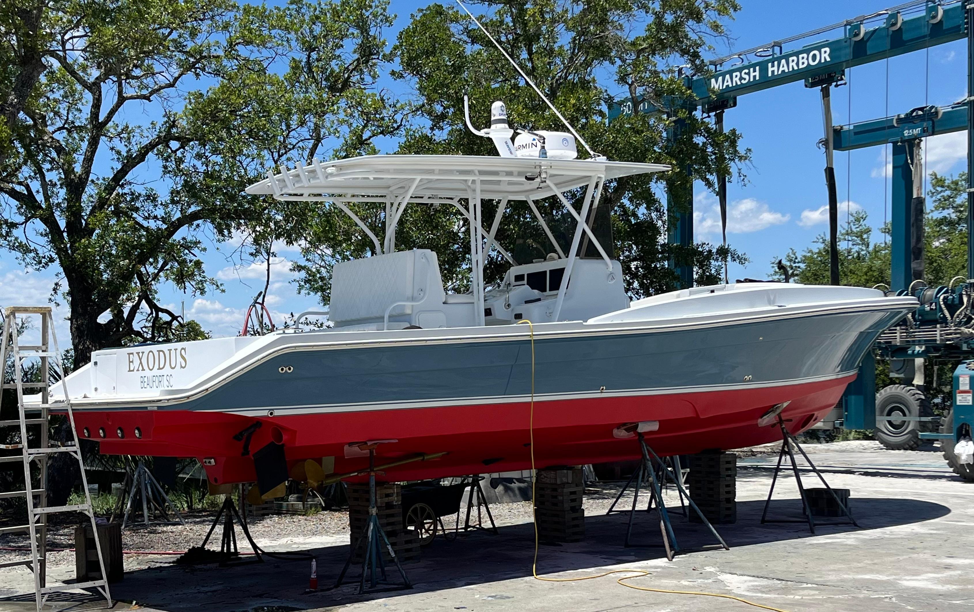 2003 Strike 35 Cuddy boat on dry dock at Marsh Harbor, featuring a red and gray hull.