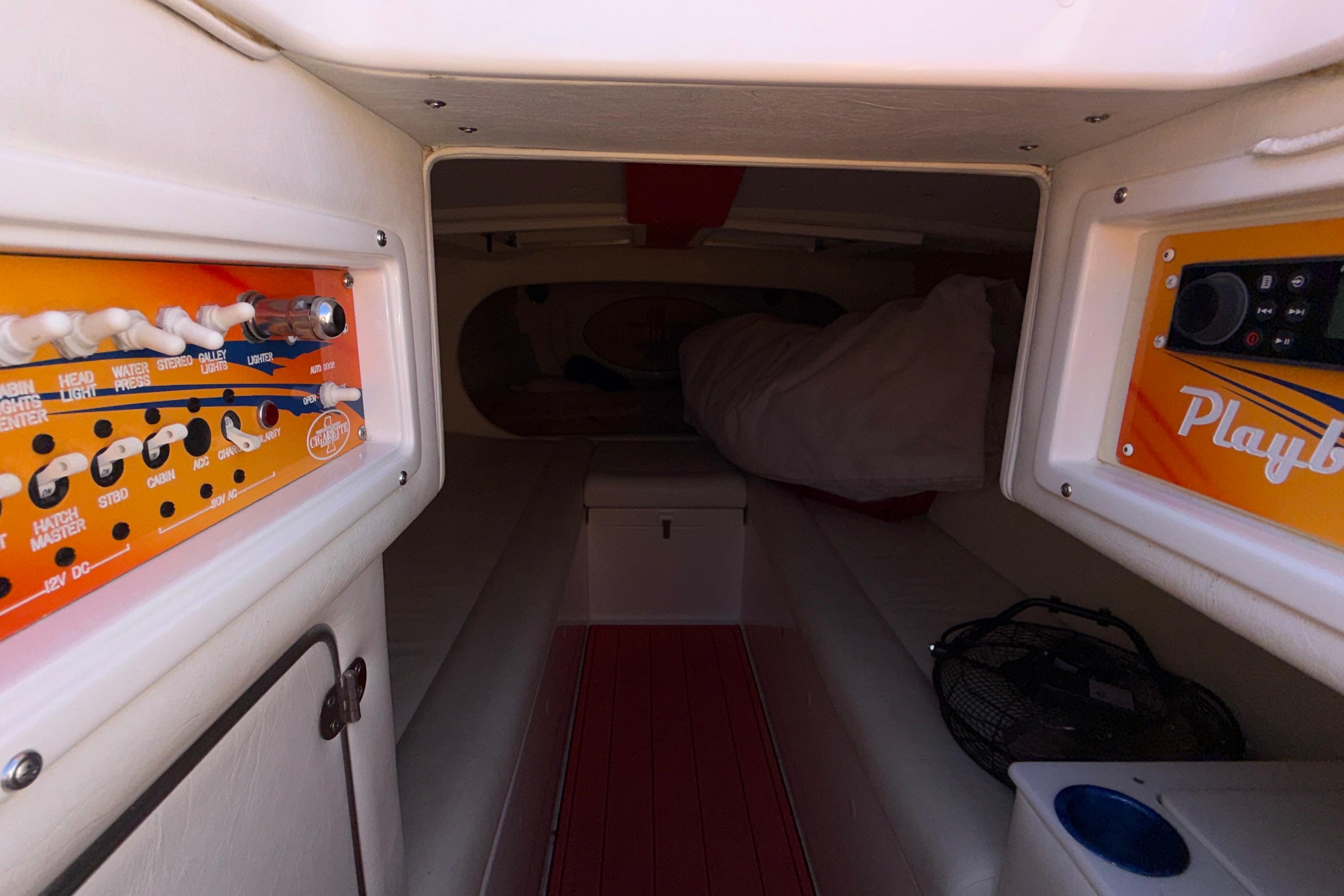 Interior of a 2002 Cigarette 35' Cafe Racer boat with control panels and seating.