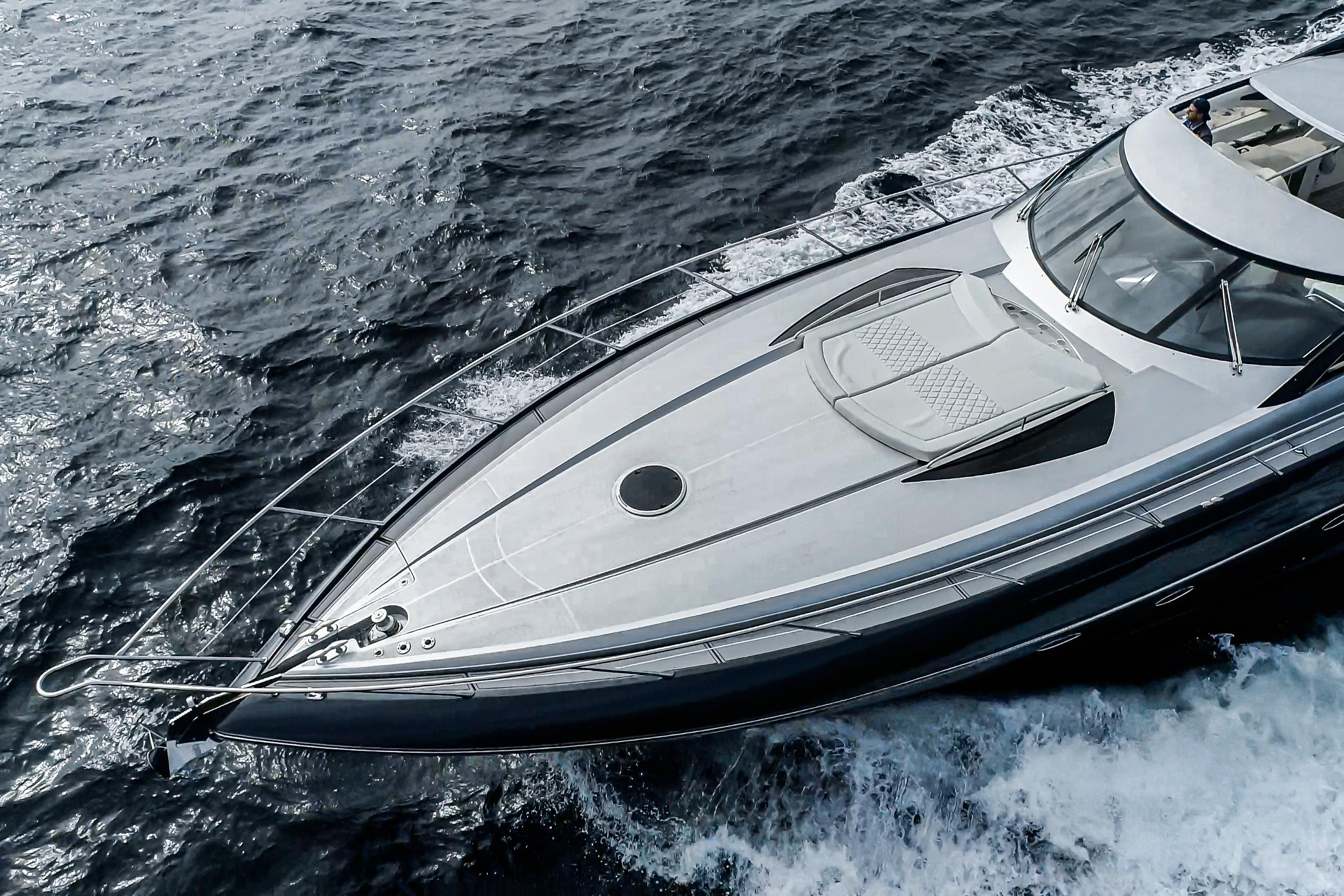 2021 Sunseeker Predator 68 yacht cruising on open water, aerial view.