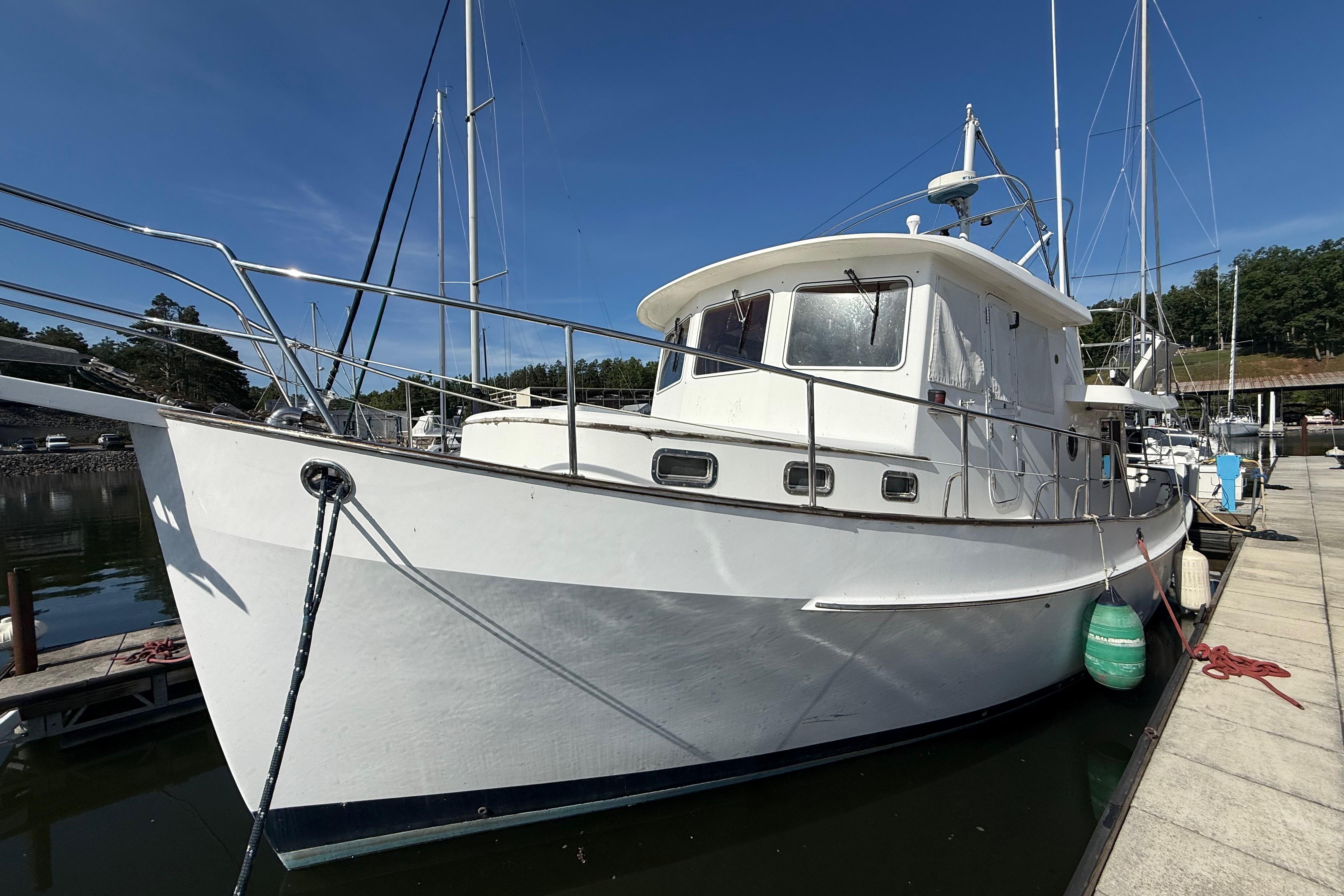 2001 Kadey-Krogen 39 yacht docked at marina under clear blue sky.
