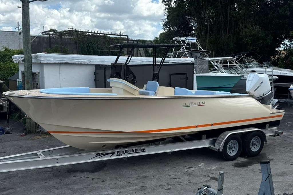 2026 Lilybaeum Levanzo 25 boat on trailer, parked outdoors under cloudy sky.
