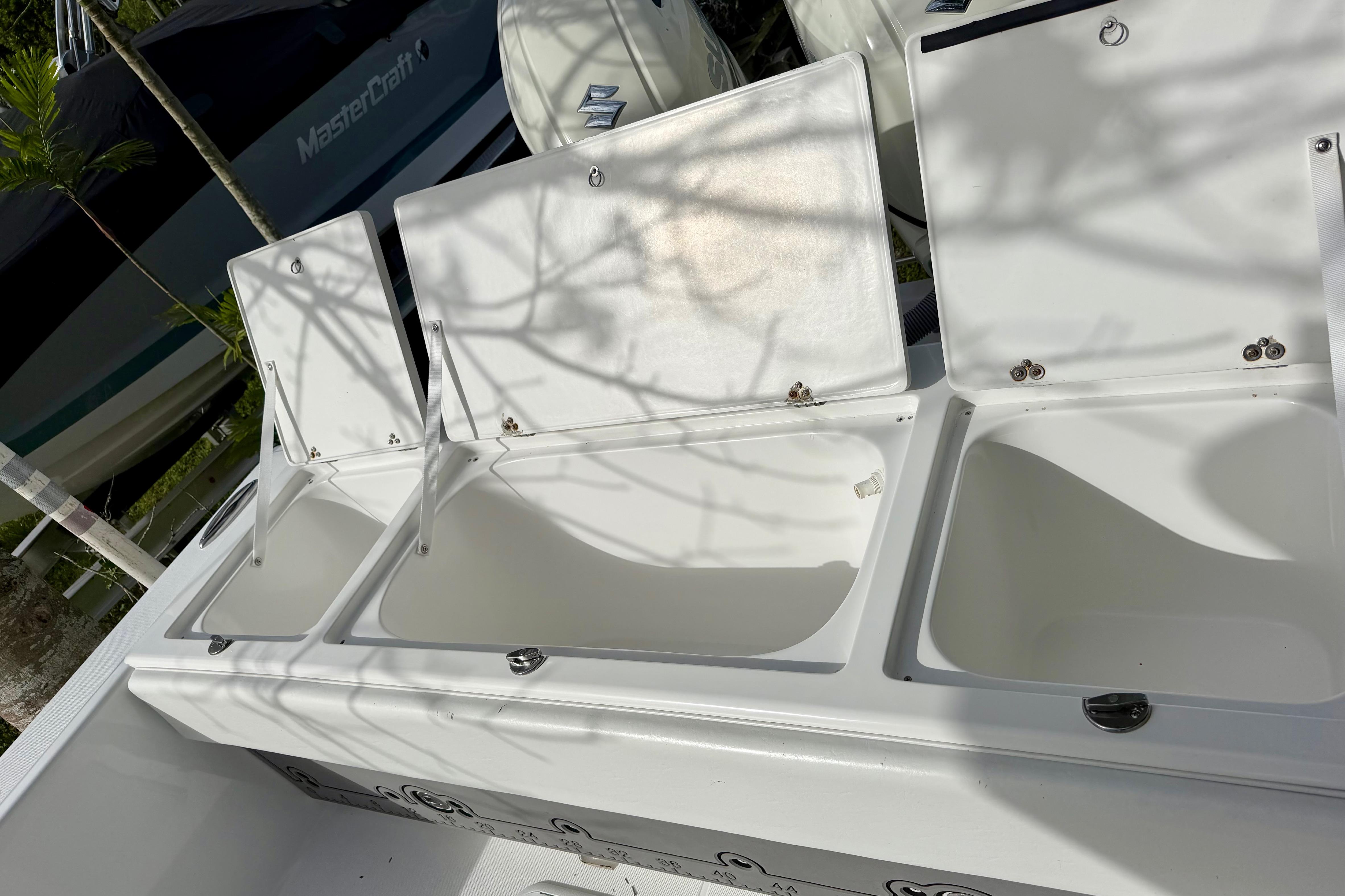 Open storage compartments on a 2025 Ocean Master 296 Center Console boat.