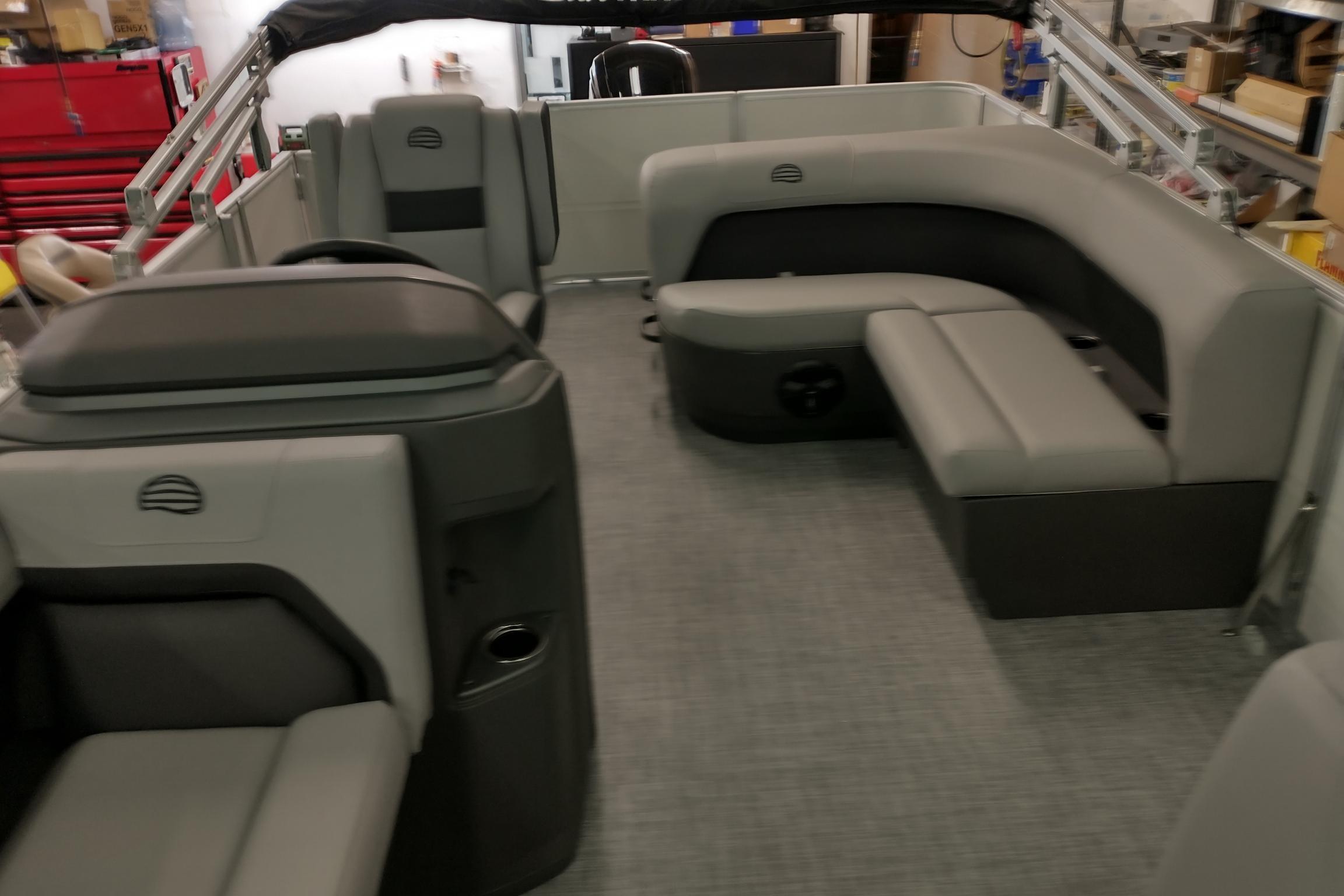 2026 Sun Tracker Party Barge 18 DLX interior with gray seating and modern design.