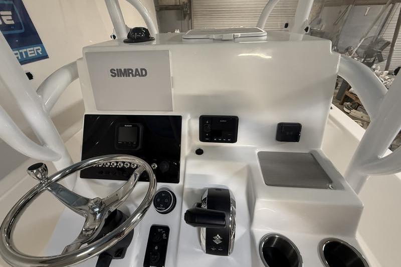 2026 Sea Pro 250 Bay boat console with Simrad electronics and steering wheel.