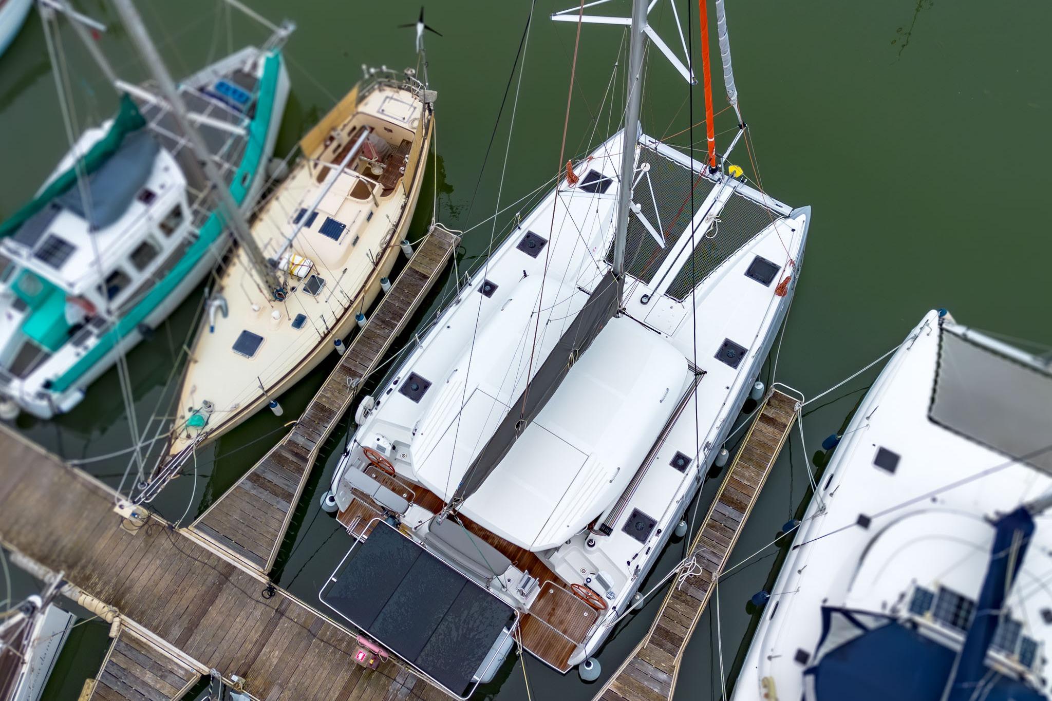 Aerial view of 2024 Excess 11 catamaran docked among sailboats.