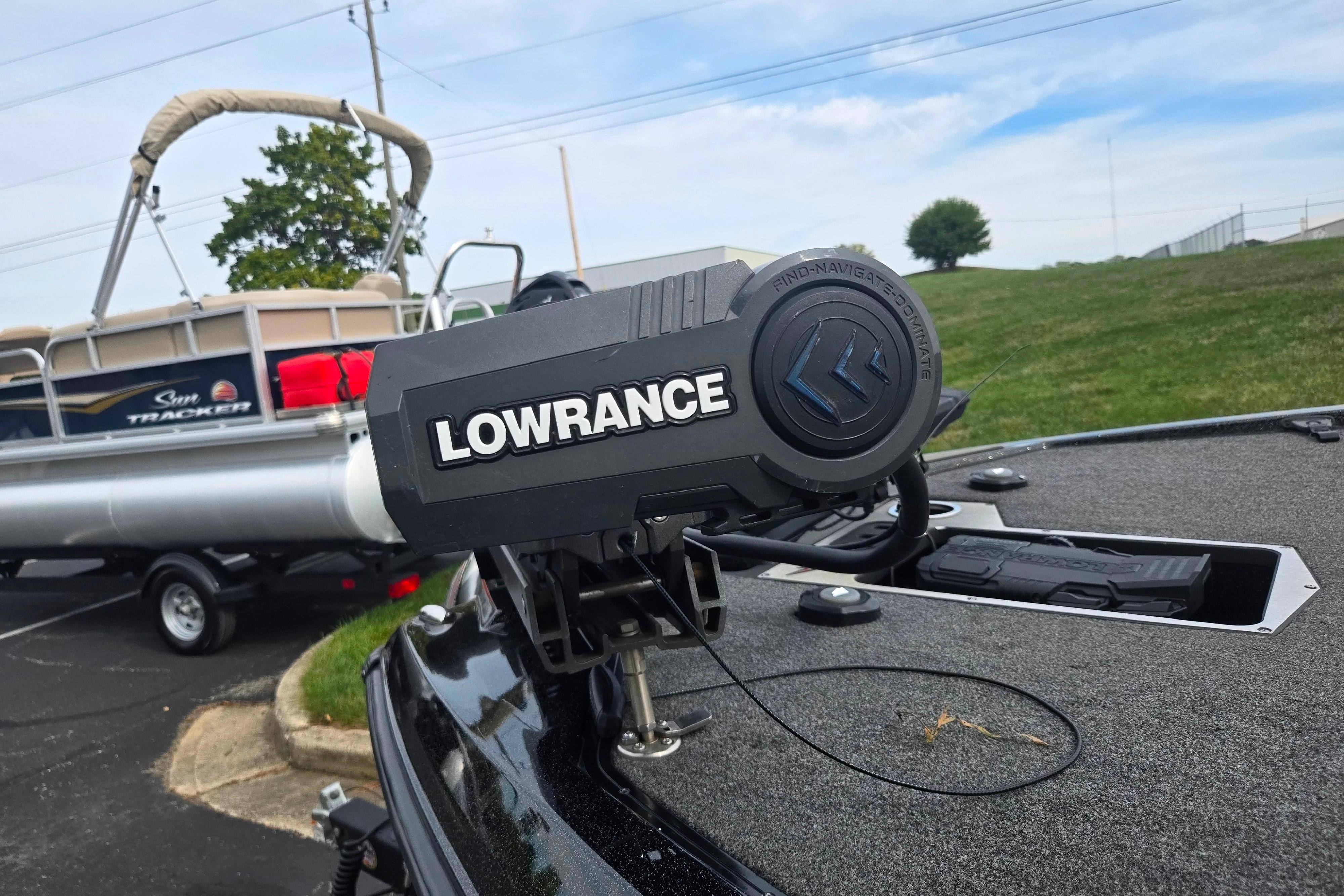 2022 Vexus VX20 boat with Lowrance equipment, parked near a Sun Tracker pontoon.