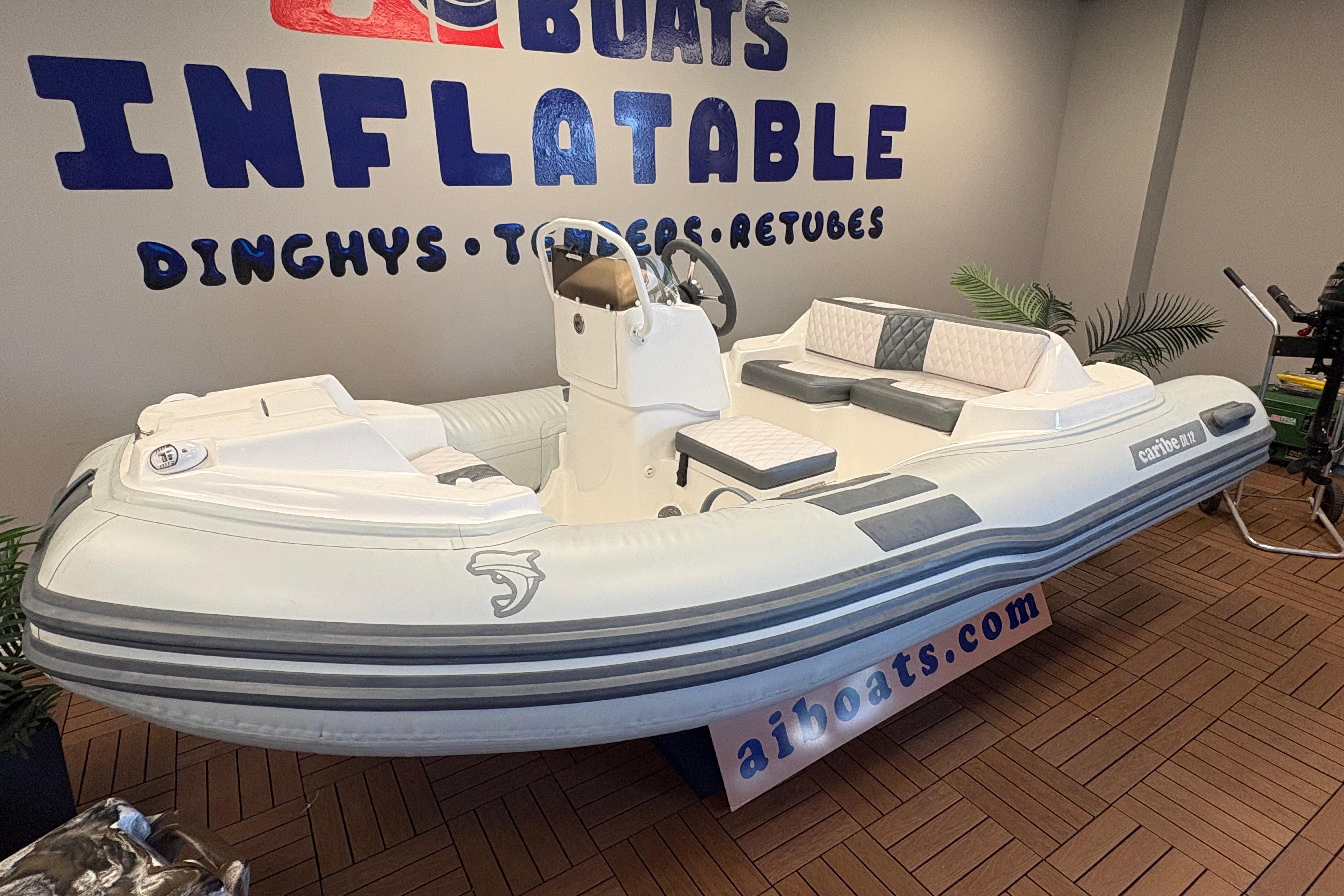 2026 Caribe DL12 inflatable boat displayed indoors with seating and steering console.