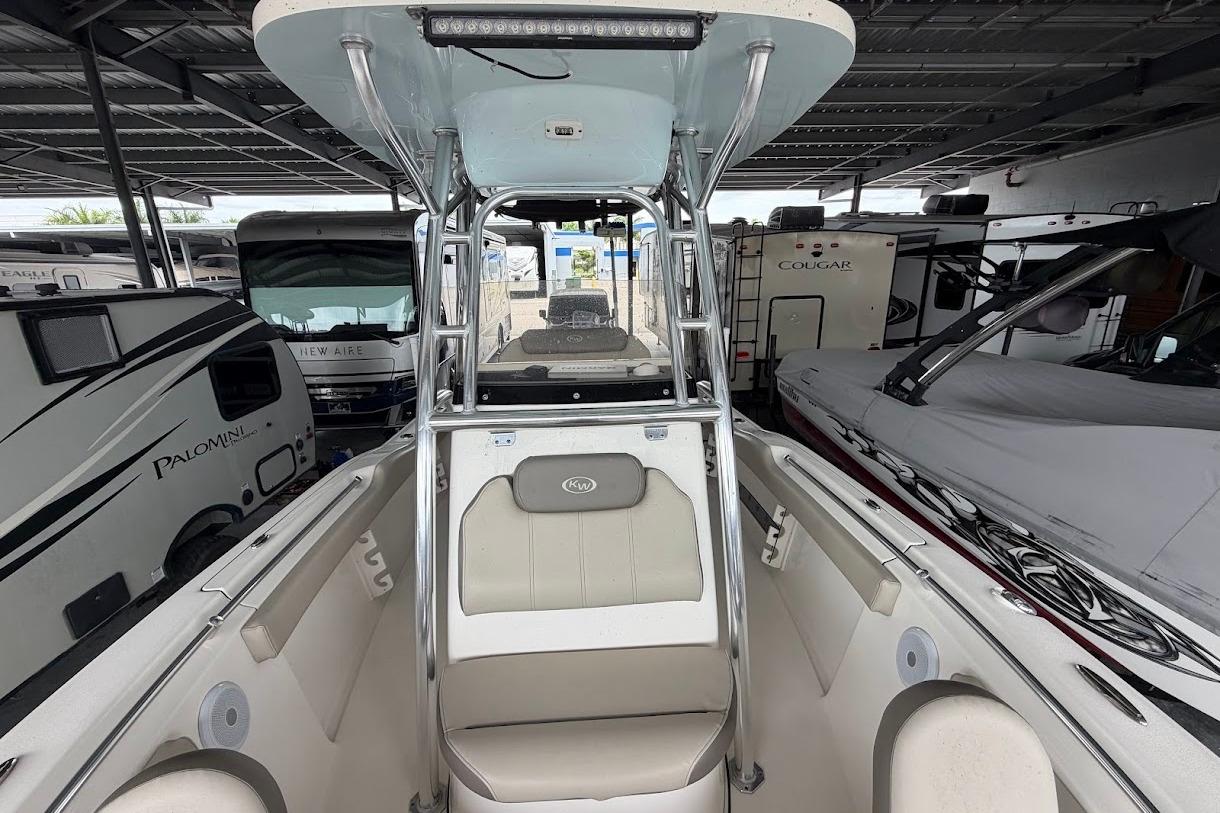 2024 Key West 219 FS boat interior with seating and canopy, surrounded by RVs.