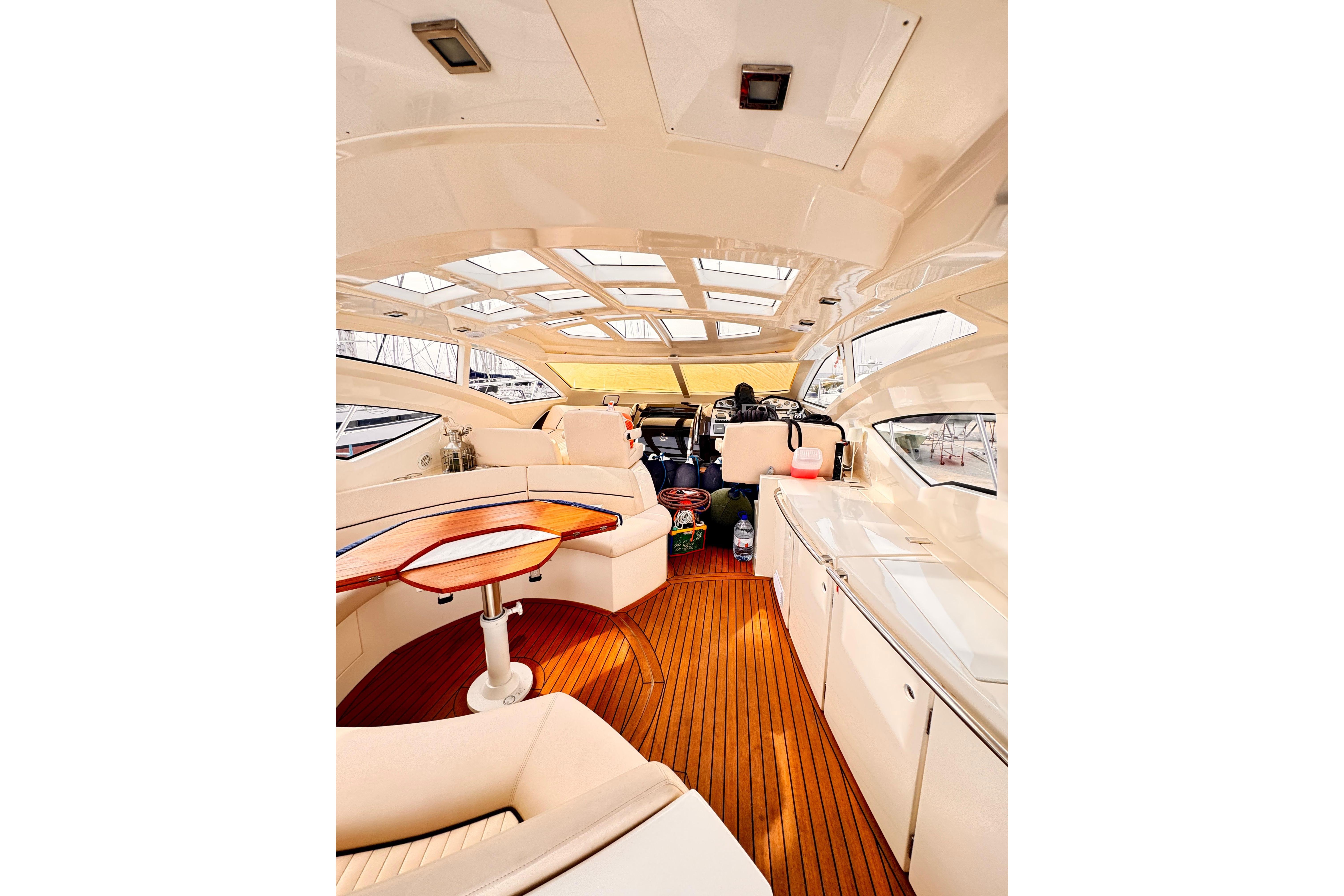 Luxurious interior of a 2007 Absolute 56 yacht with elegant seating and wooden flooring.