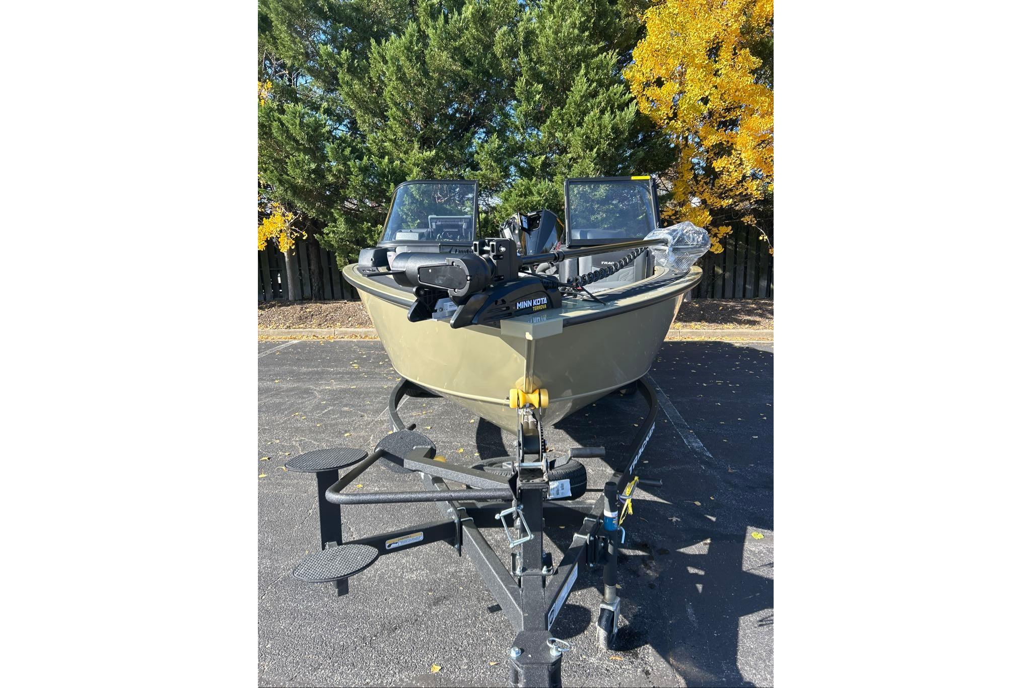 2026 Tracker Targa V-19 Combo boat on trailer, parked outdoors with trees in background.