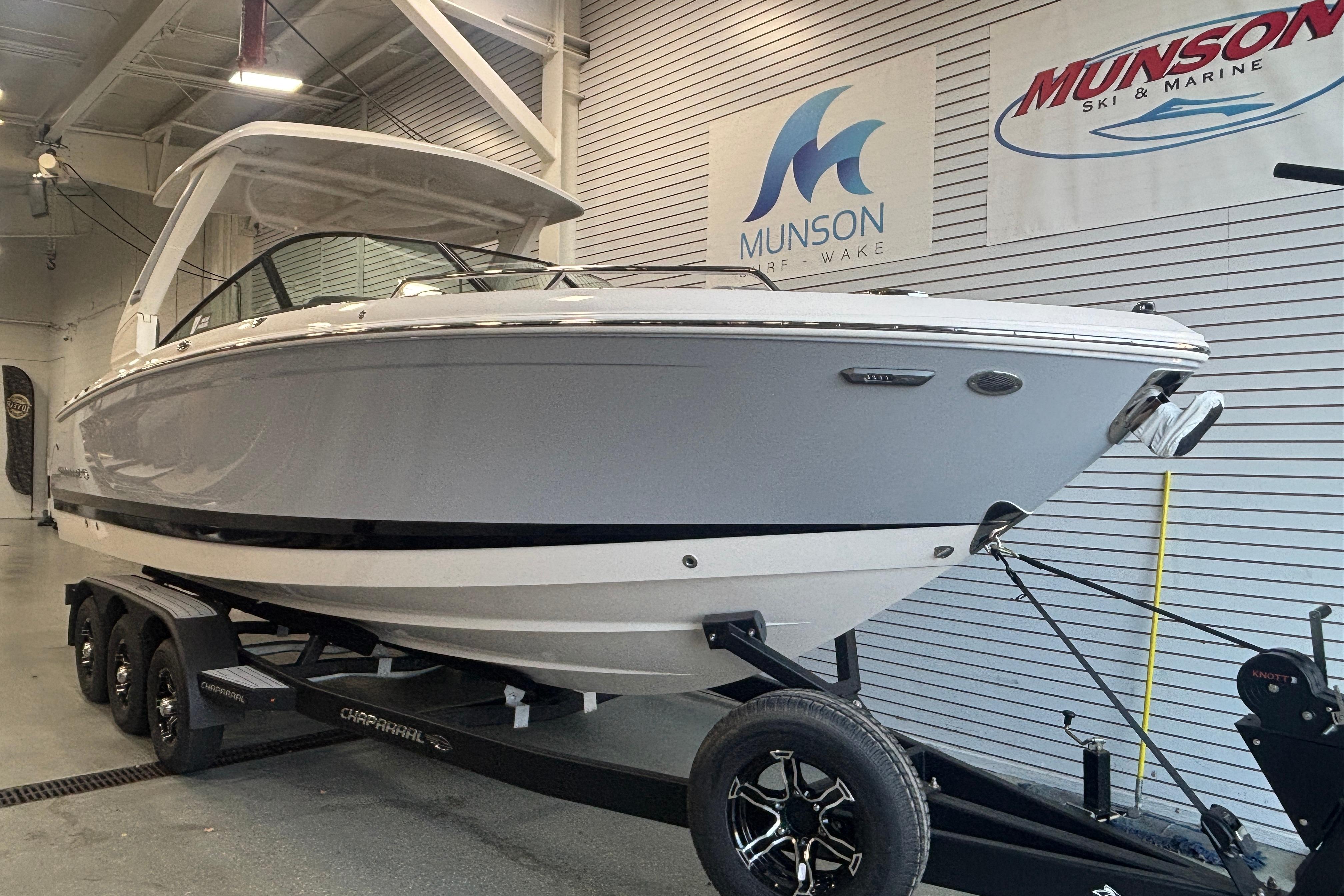 2026 Chaparral SSX 30 boat on trailer in showroom, Munson Ski & Marine signage.