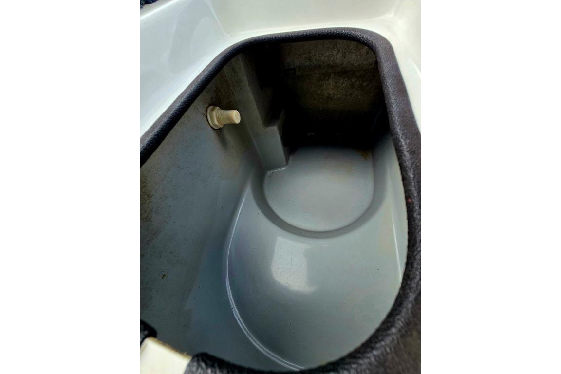 Interior compartment of a 1996 Champion 181 SX boat, showcasing storage space.