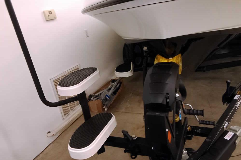 2026 Ranger 620xFS Pro boat trailer with step ladder in a garage.