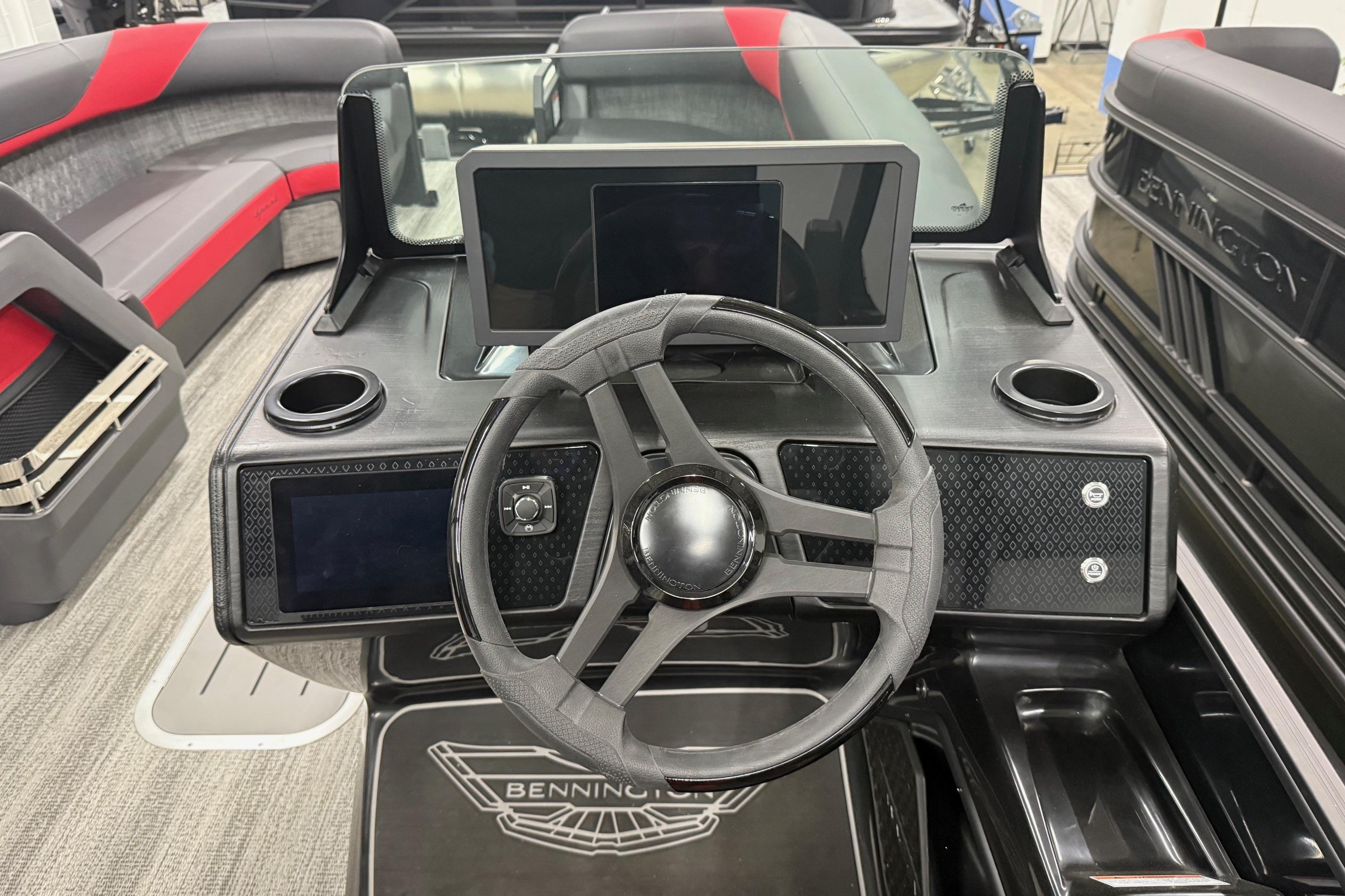 2025 Bennington M Line boat dashboard with steering wheel and digital displays.