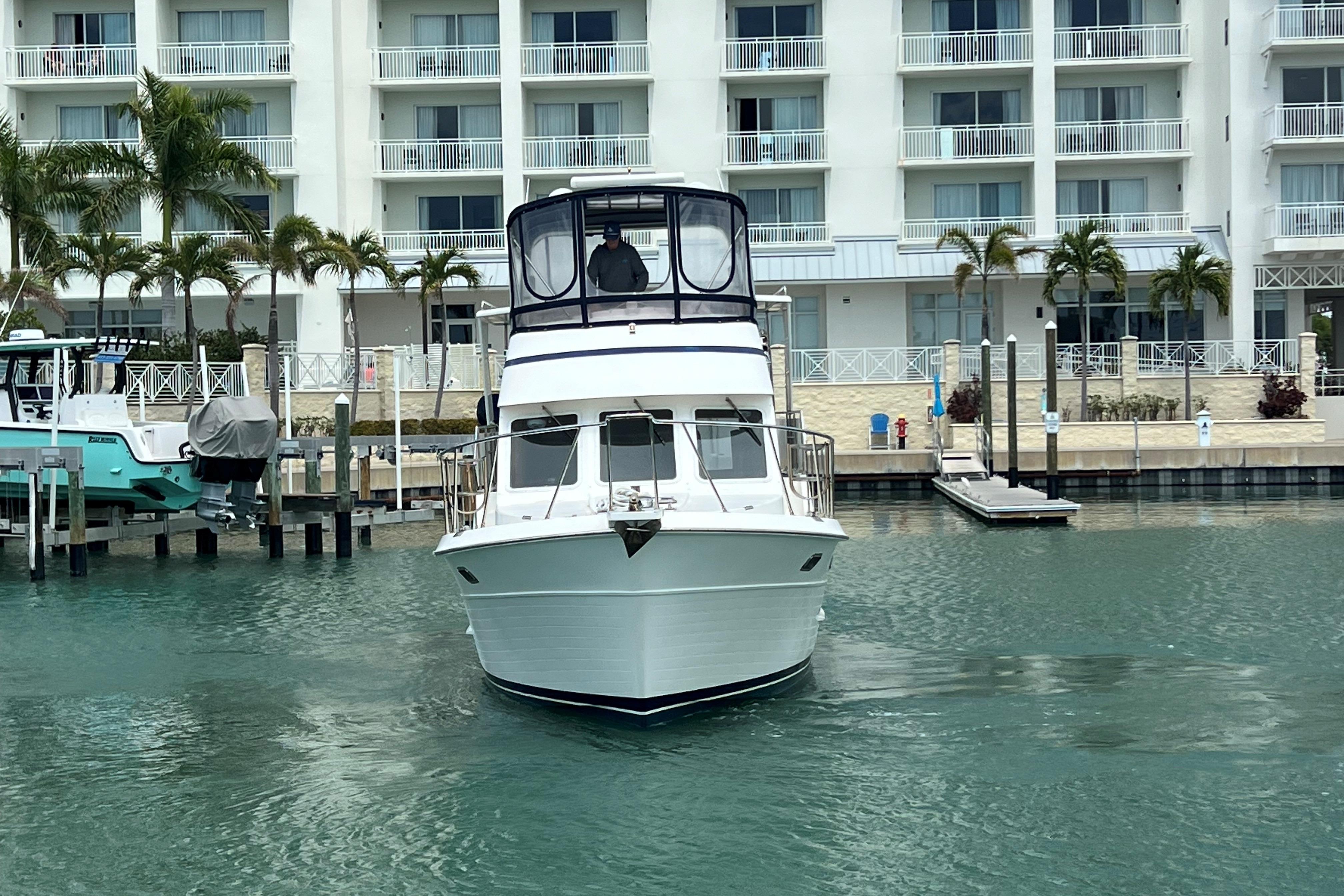 2007 Heritage East 36 Sundeck Trawler docked near waterfront building.