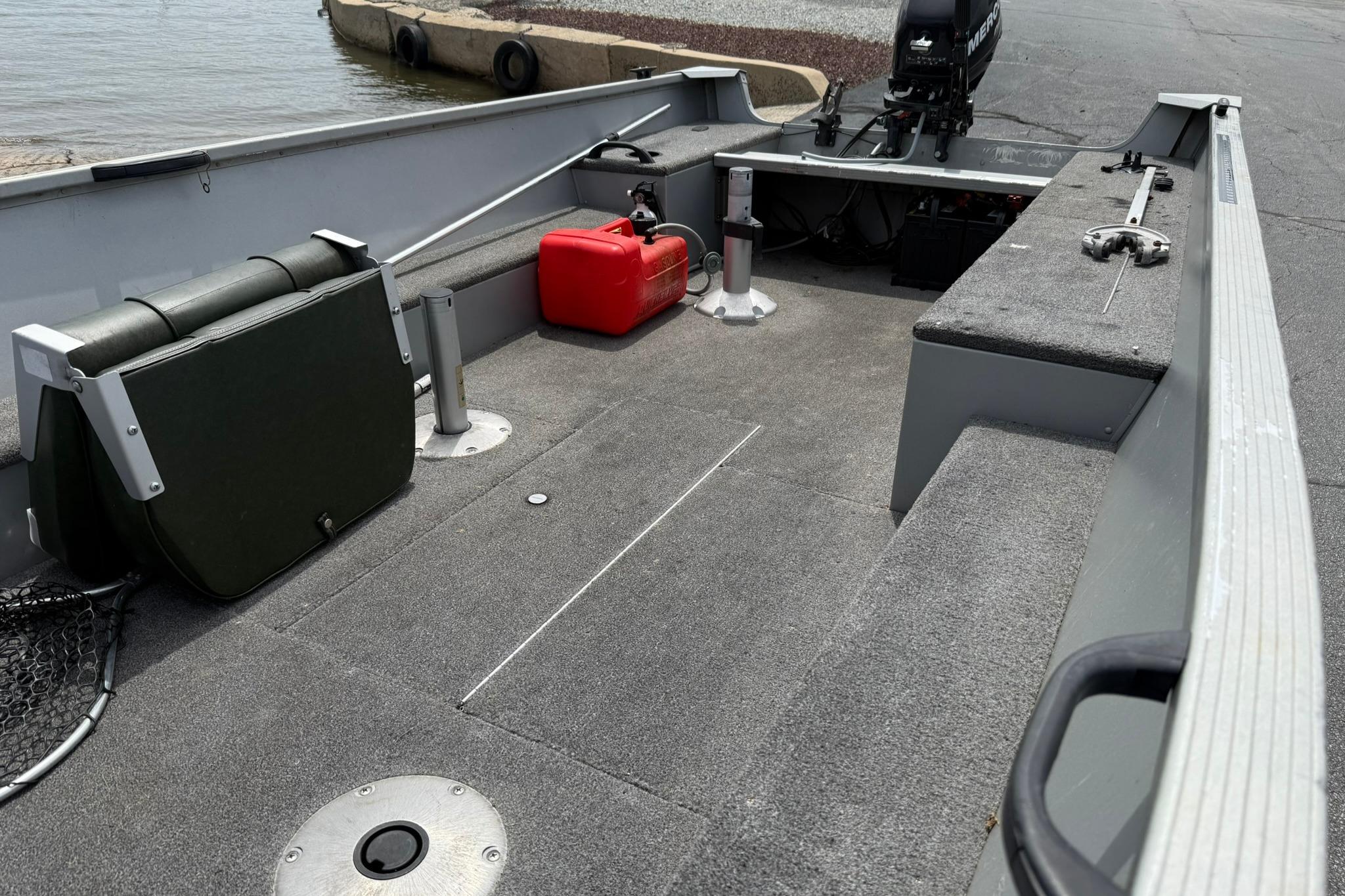 2013 Alumacraft Fisherman 160 Tiller boat interior with seating and storage compartments.