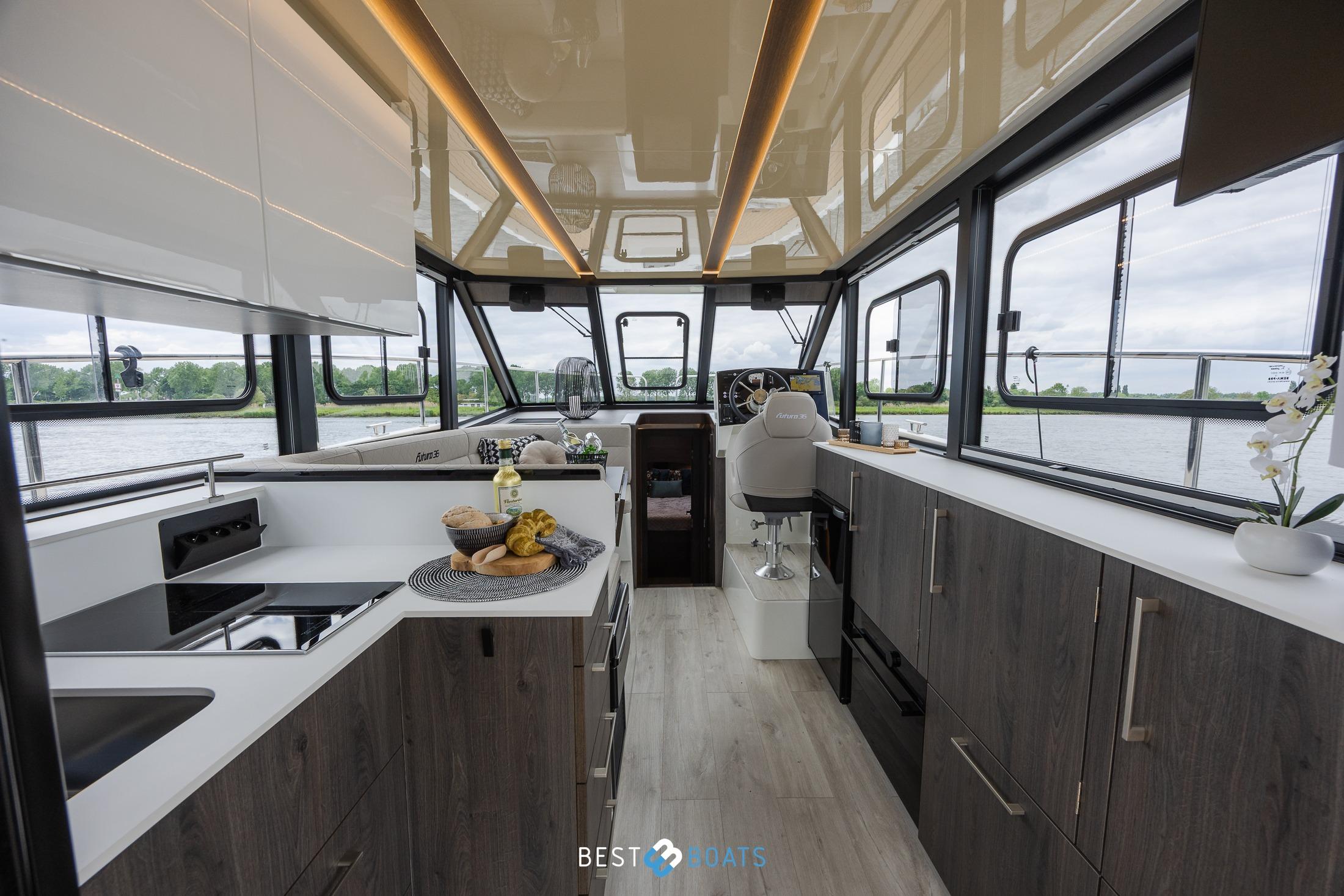 Modern interior of 2023 Cobra Yachts Futura 36 Premium Fly, featuring sleek kitchen and helm.