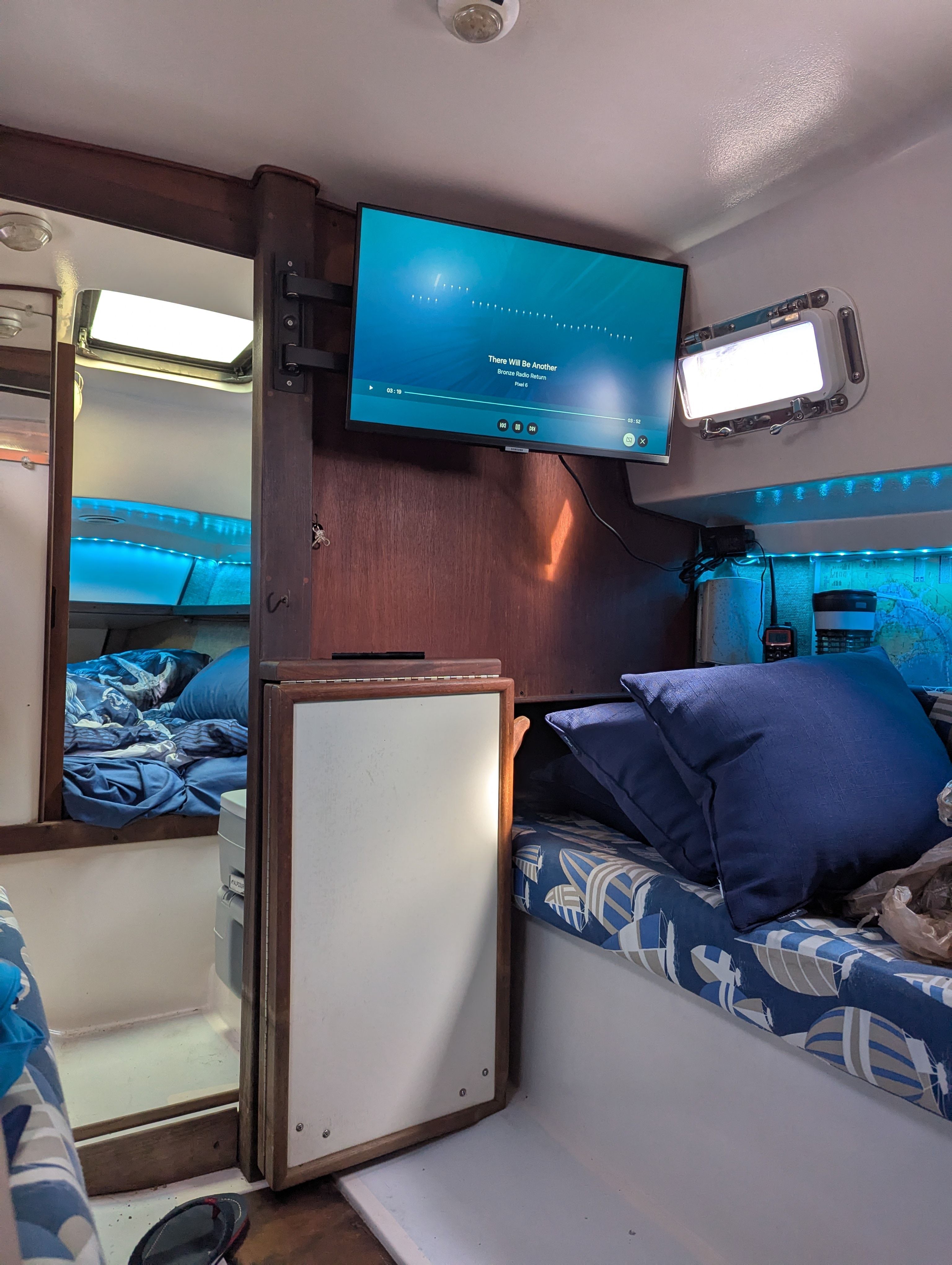 Interior of a 1982 Hunter 25.5 with cozy berths and a television.