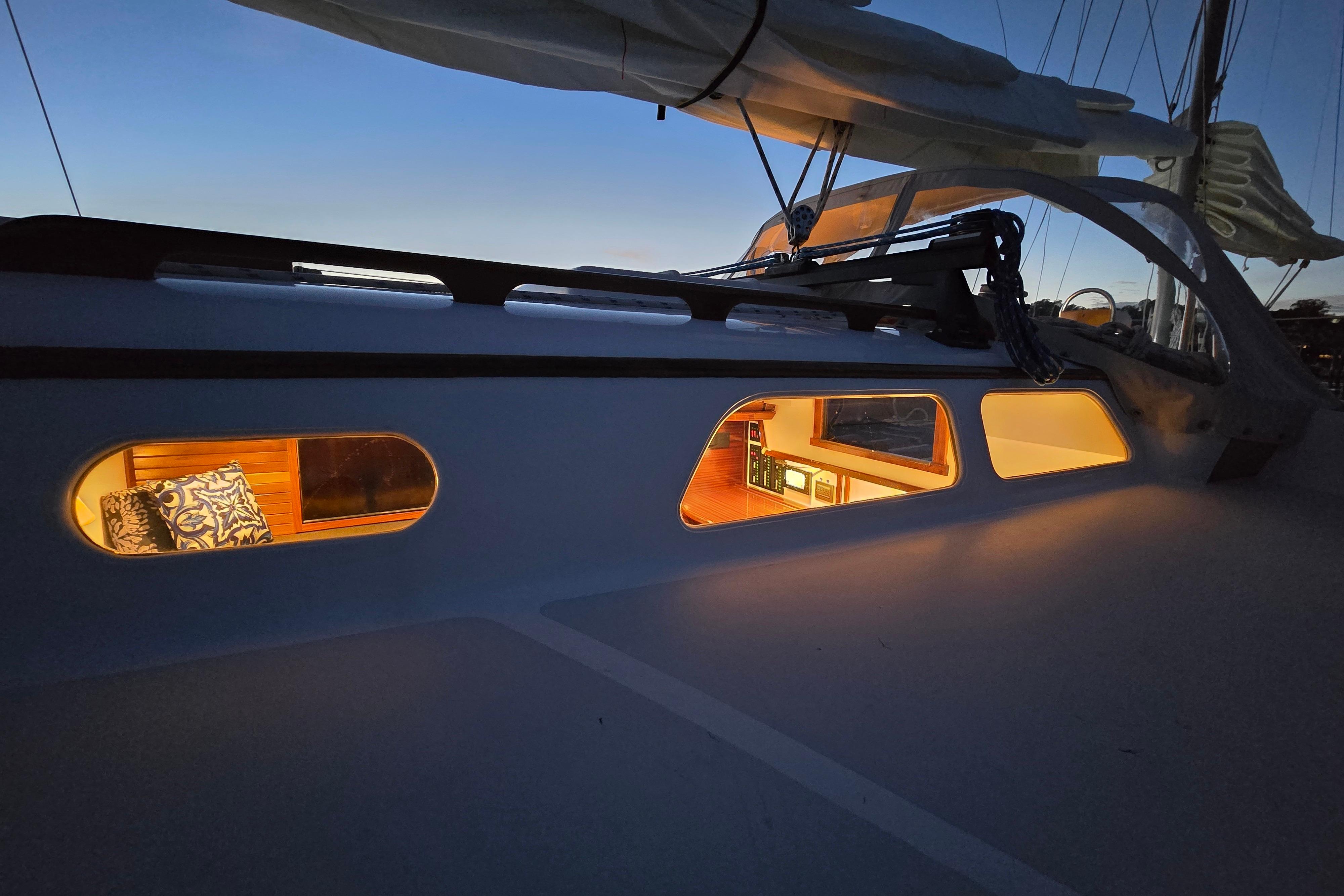 1970 Hinckley Bermuda 40 sailboat interior warmly lit at dusk.
