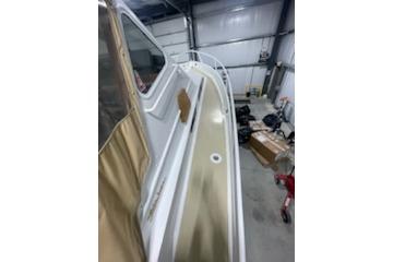 1964 Striker Model 120 boat in a garage, showcasing its sleek design and structure.