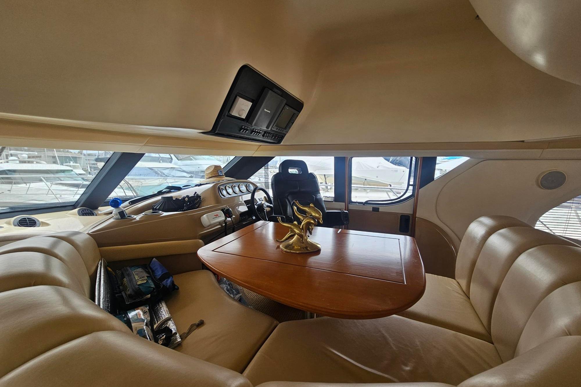 Luxurious interior of 2002 Carver 450 Voyager Pilothouse with plush seating and elegant table.