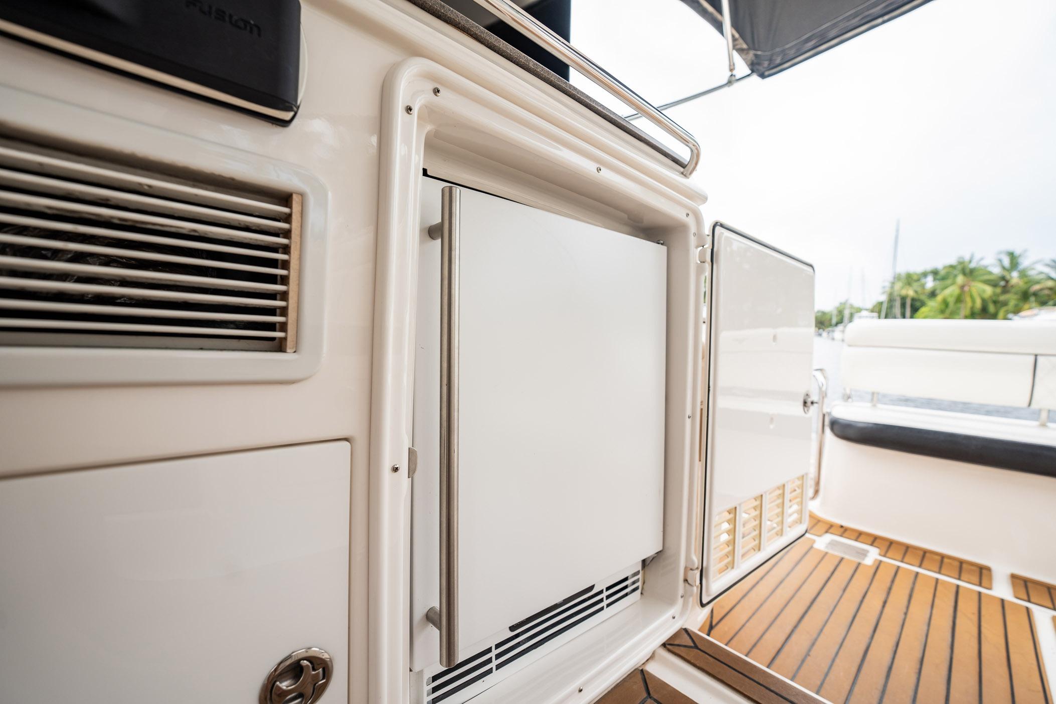 2008 Regal Commodore 4460 yacht interior with open cabinet and teak flooring.