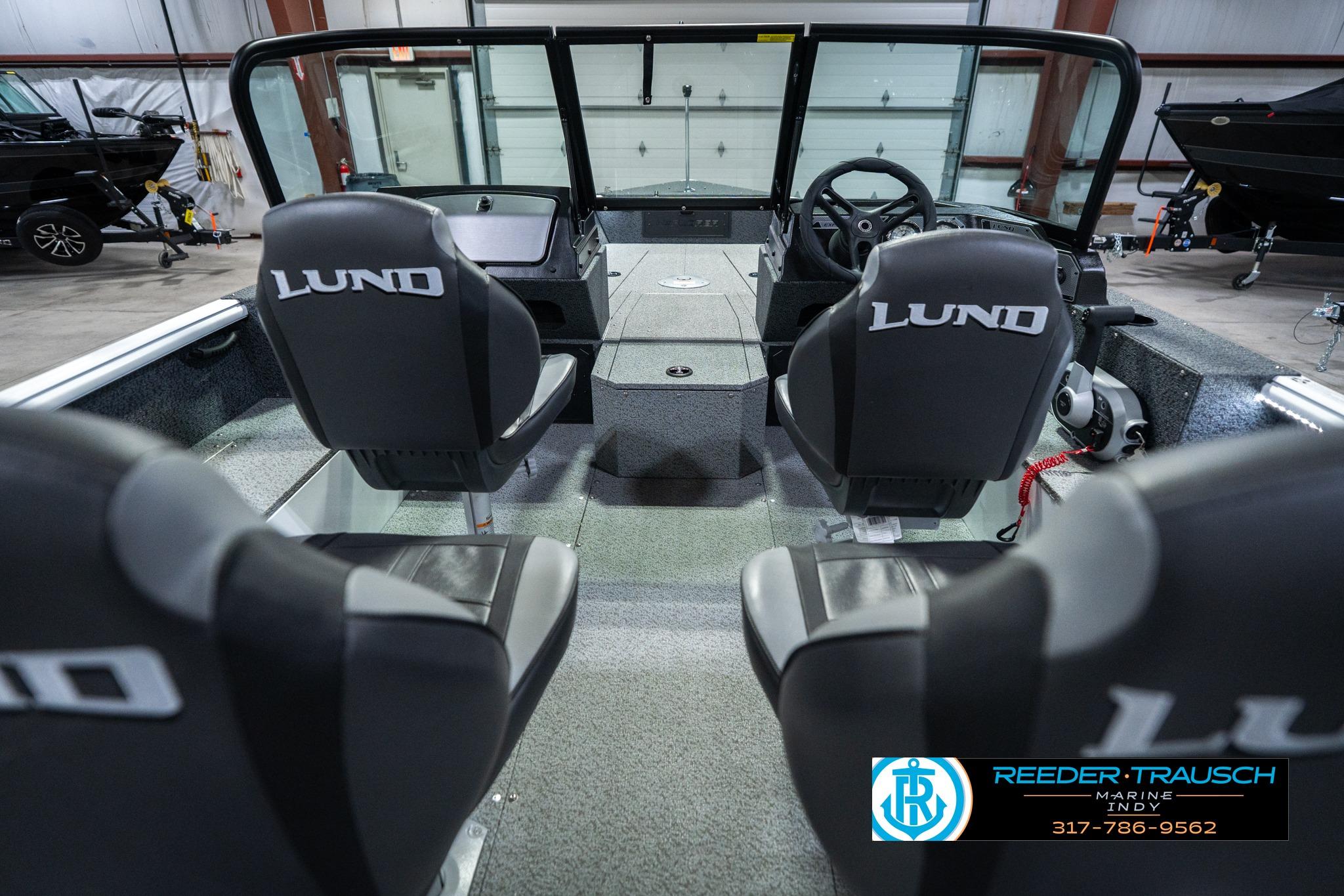 Interior view of 2026 Lund 1700 Explorer Sport boat with seating and steering wheel.