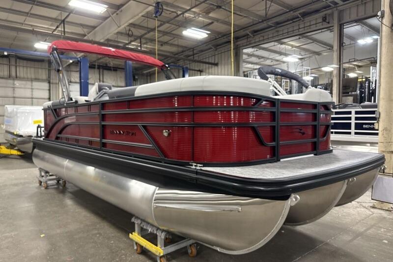 2026 Bennington 22 SSRSF pontoon boat with red exterior in a warehouse setting.