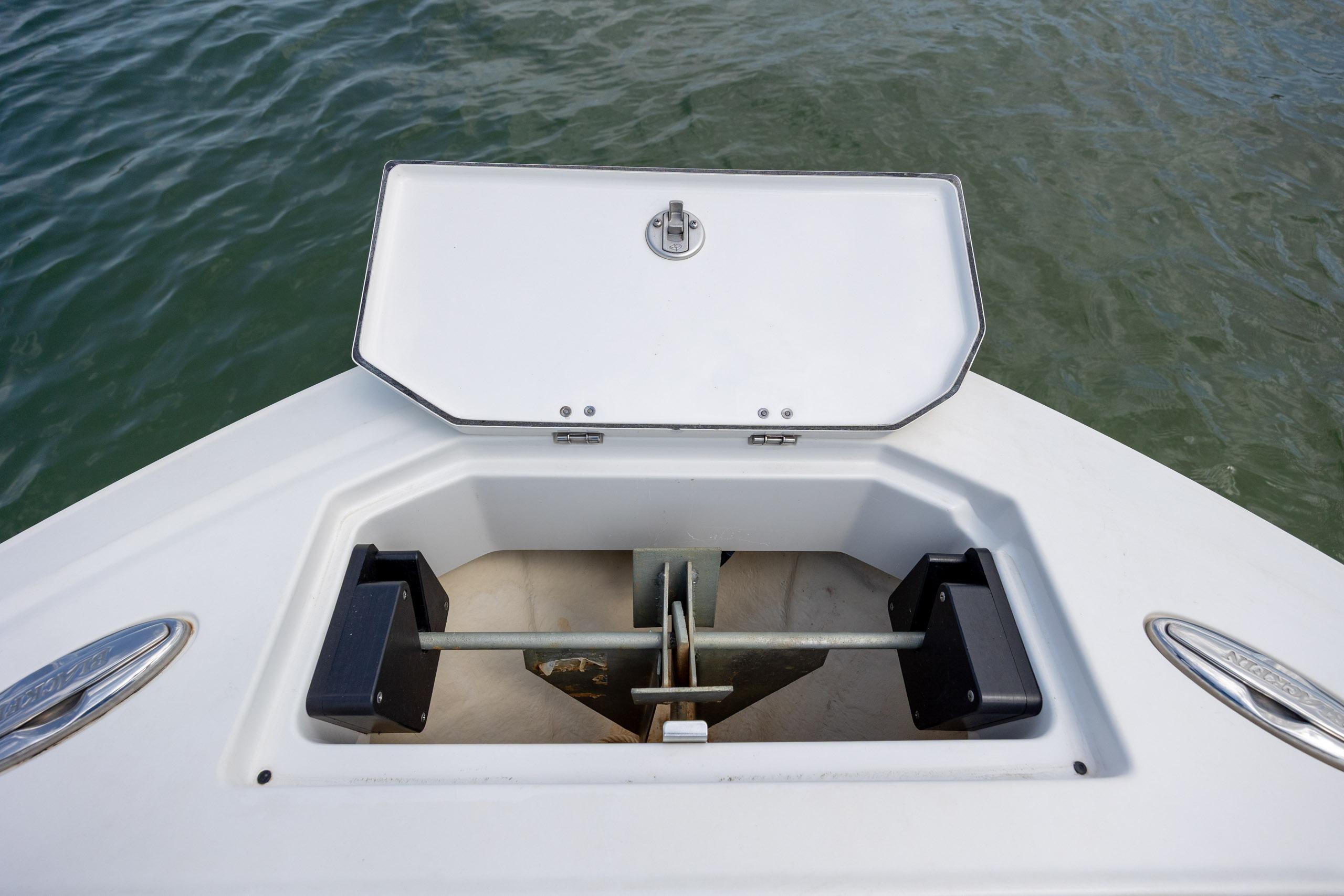 Anchor compartment of 2019 Blackfin 212 CC boat, open lid, on calm water.