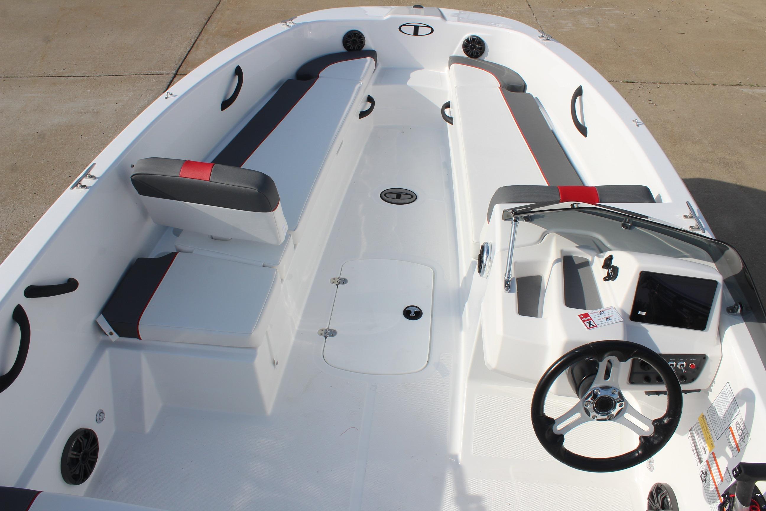 2026 Tahoe T18 boat interior with seating, steering wheel, and dashboard controls.