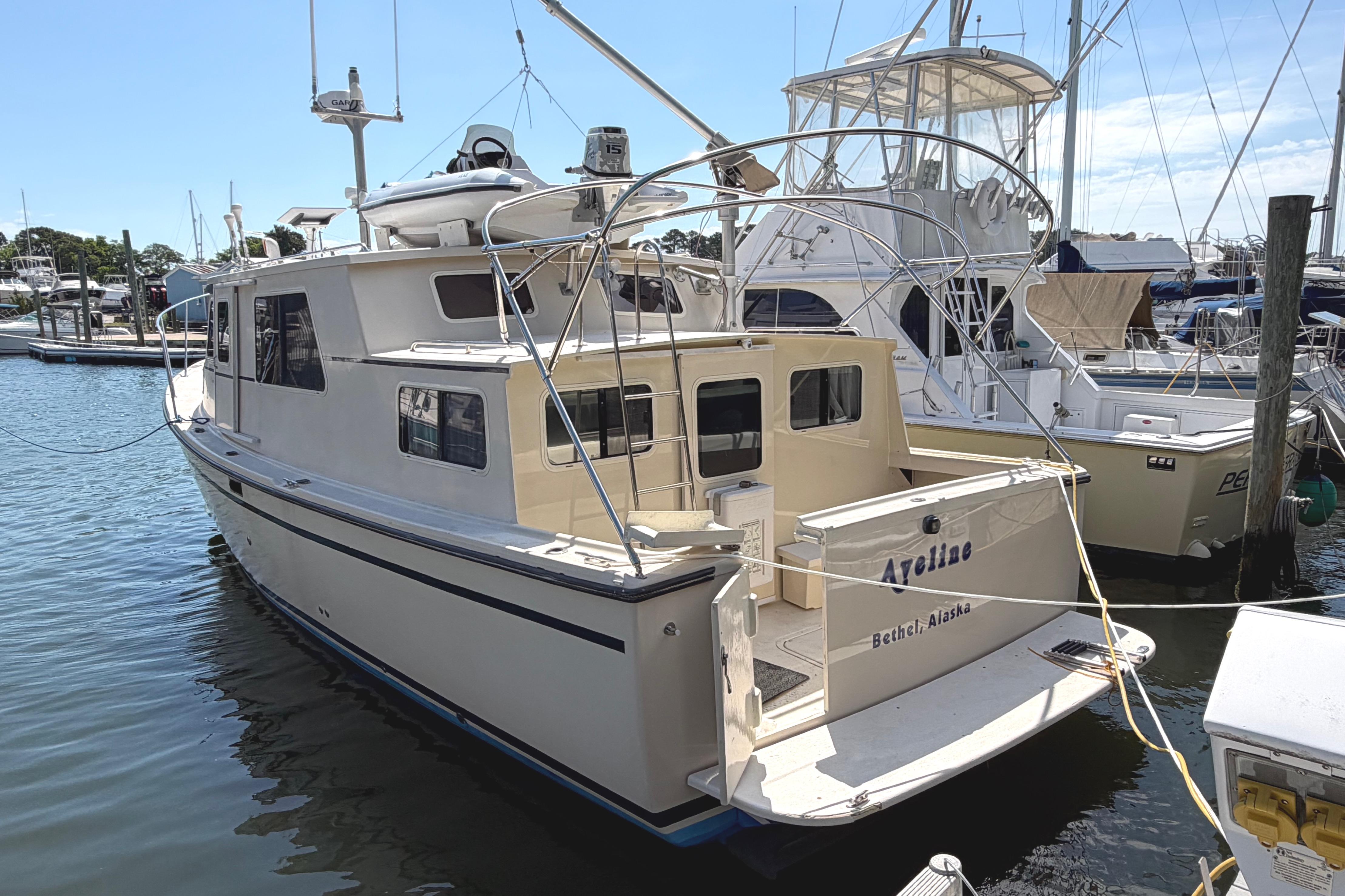 1997 Rosborough Trawler docked at marina, featuring spacious deck and classic design.