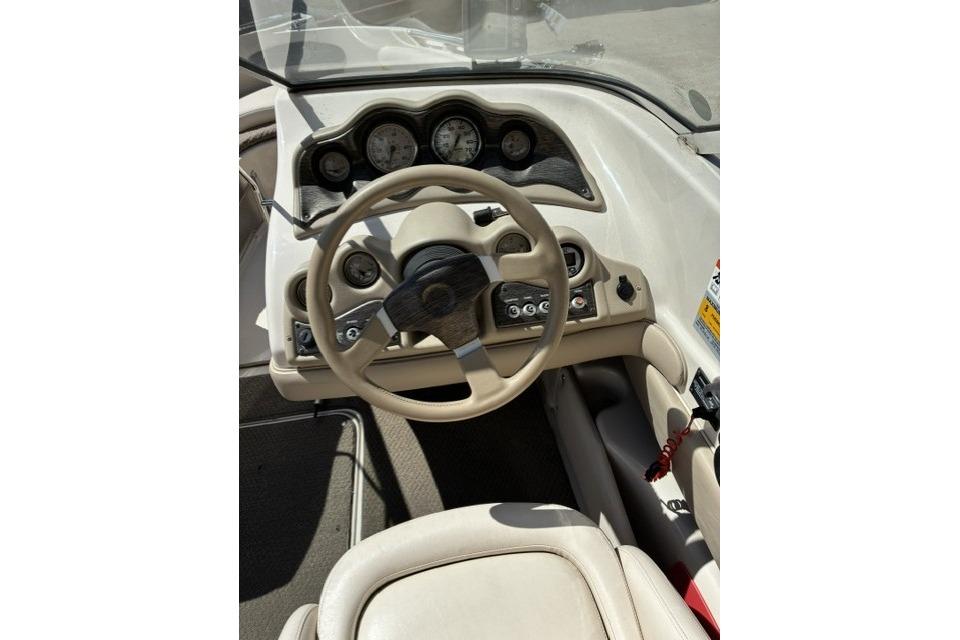 2003 Glastron GX 185 Ski & Fish boat dashboard with steering wheel and gauges.