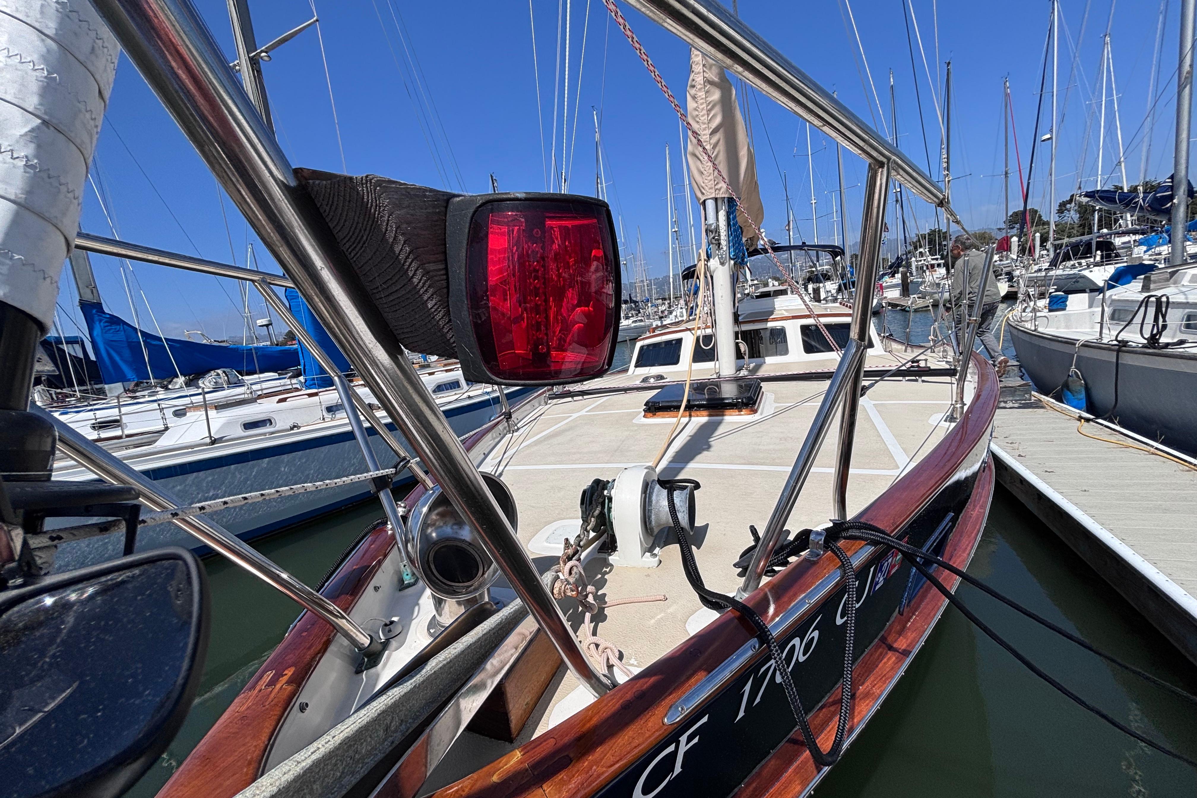 1978 Swift 33 sailboat docked at marina, featuring deck and rigging details.