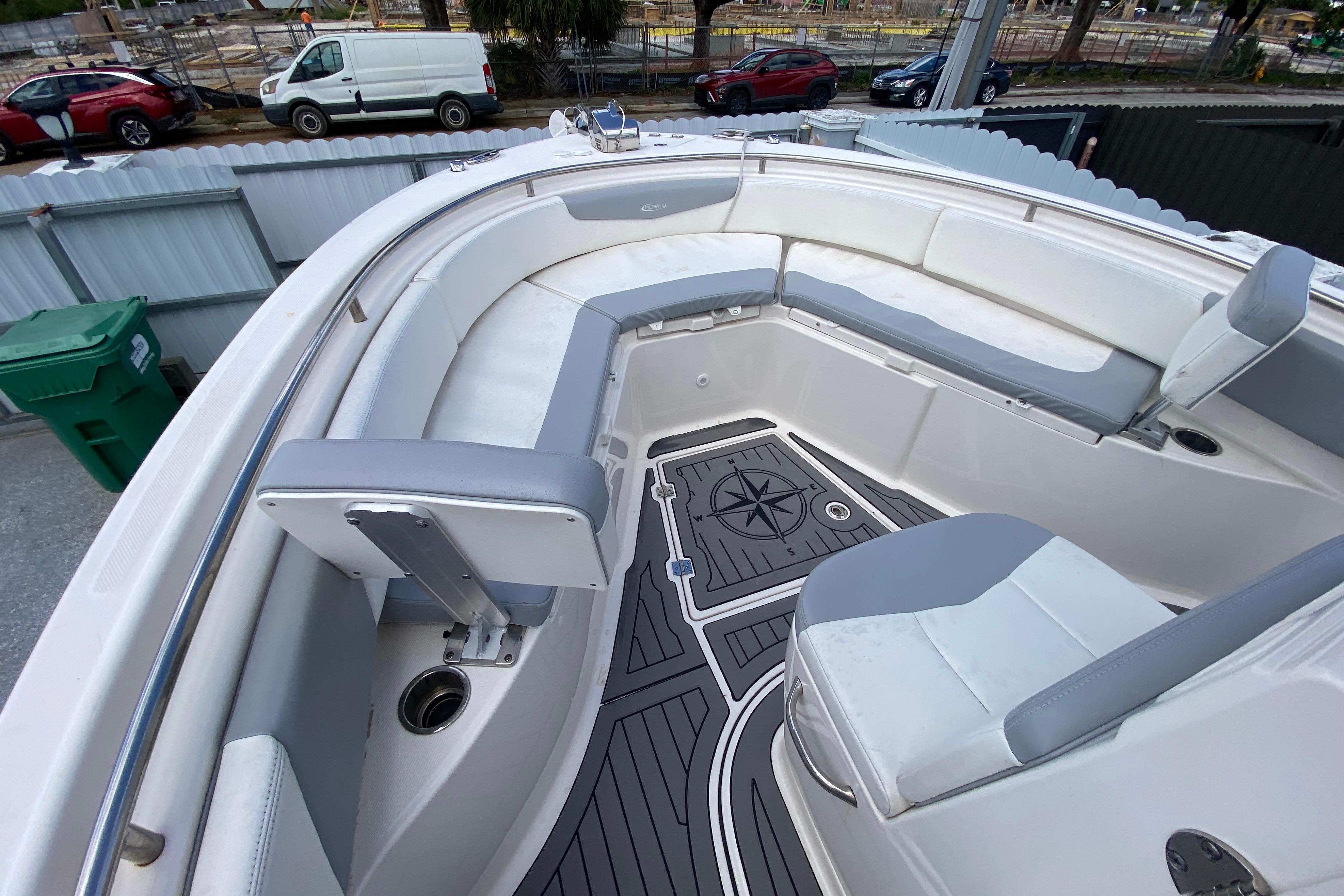 2022 Robalo R242 Center Console boat interior with cushioned seating and compass design flooring.