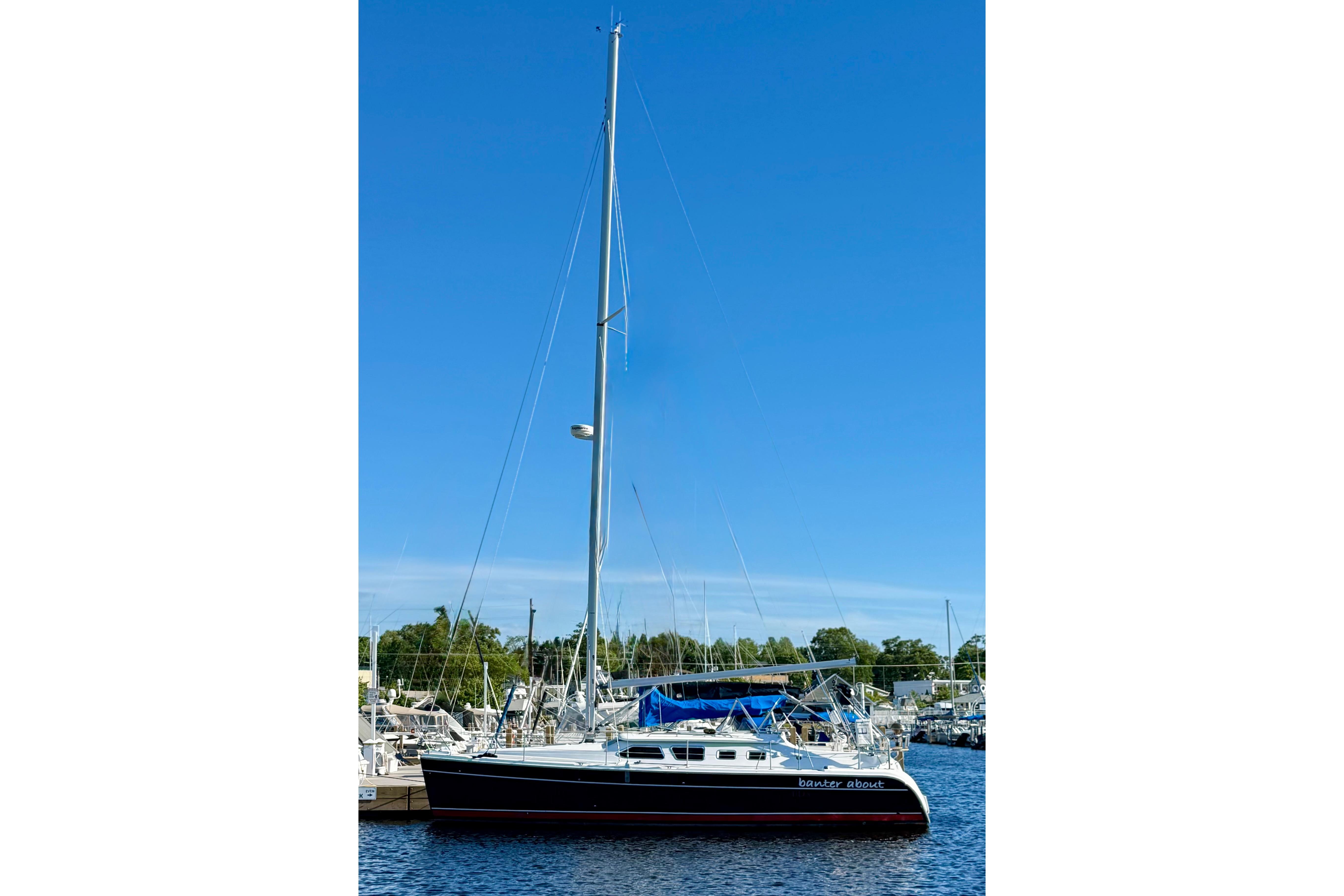 2007 Hunter 41 Deck Salon sailboat docked at marina under clear blue sky.