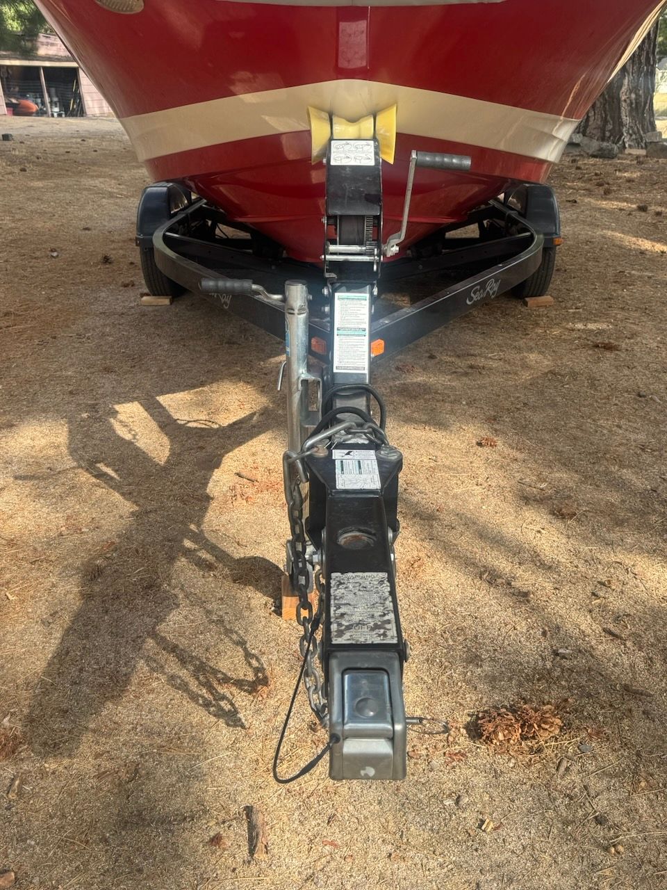 The bow of a red 2016 Sea Ray SPX 190 Outboard on a trailer.