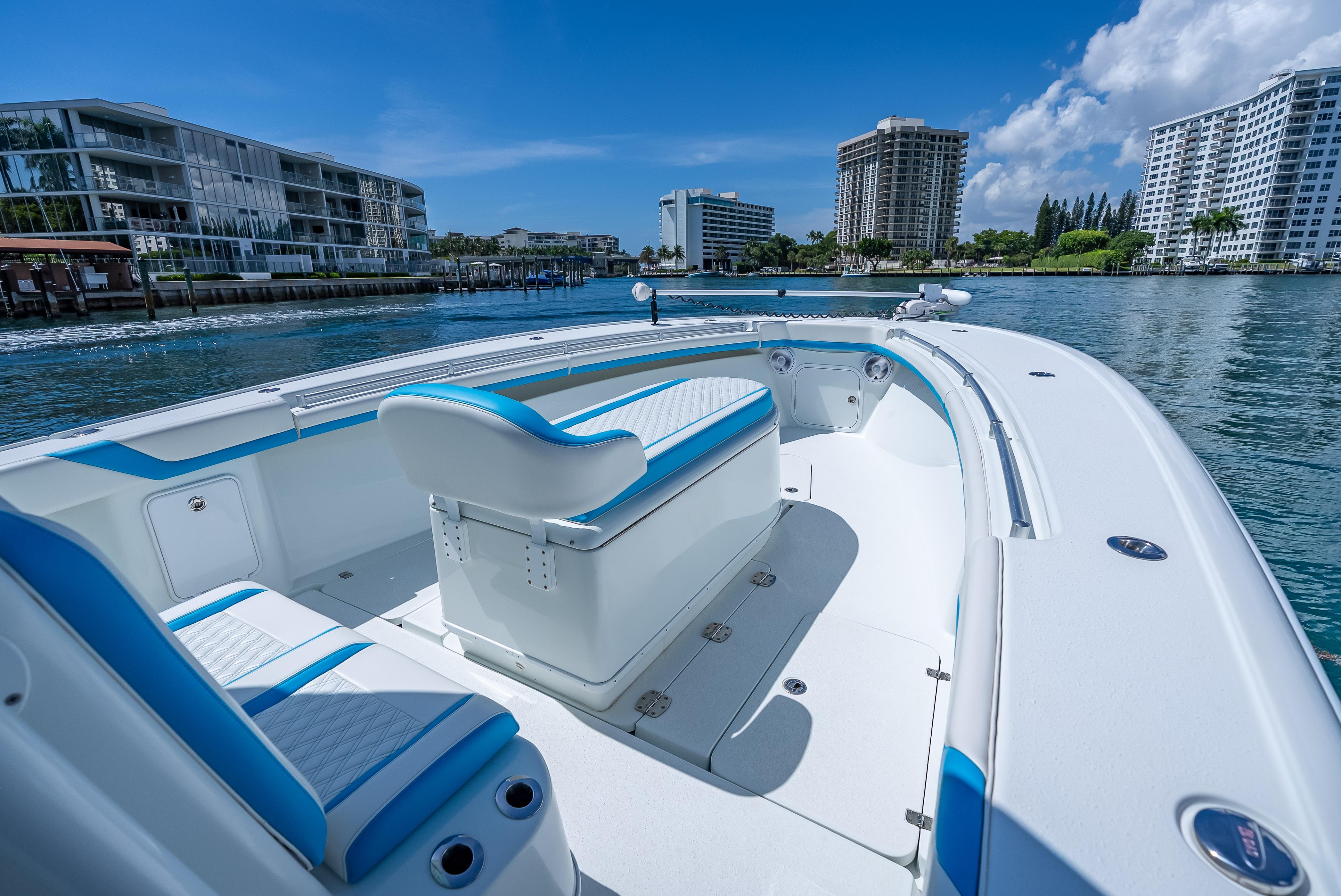 2016 Yellowfin 39 Offshore boat on calm water, with modern buildings in the background.