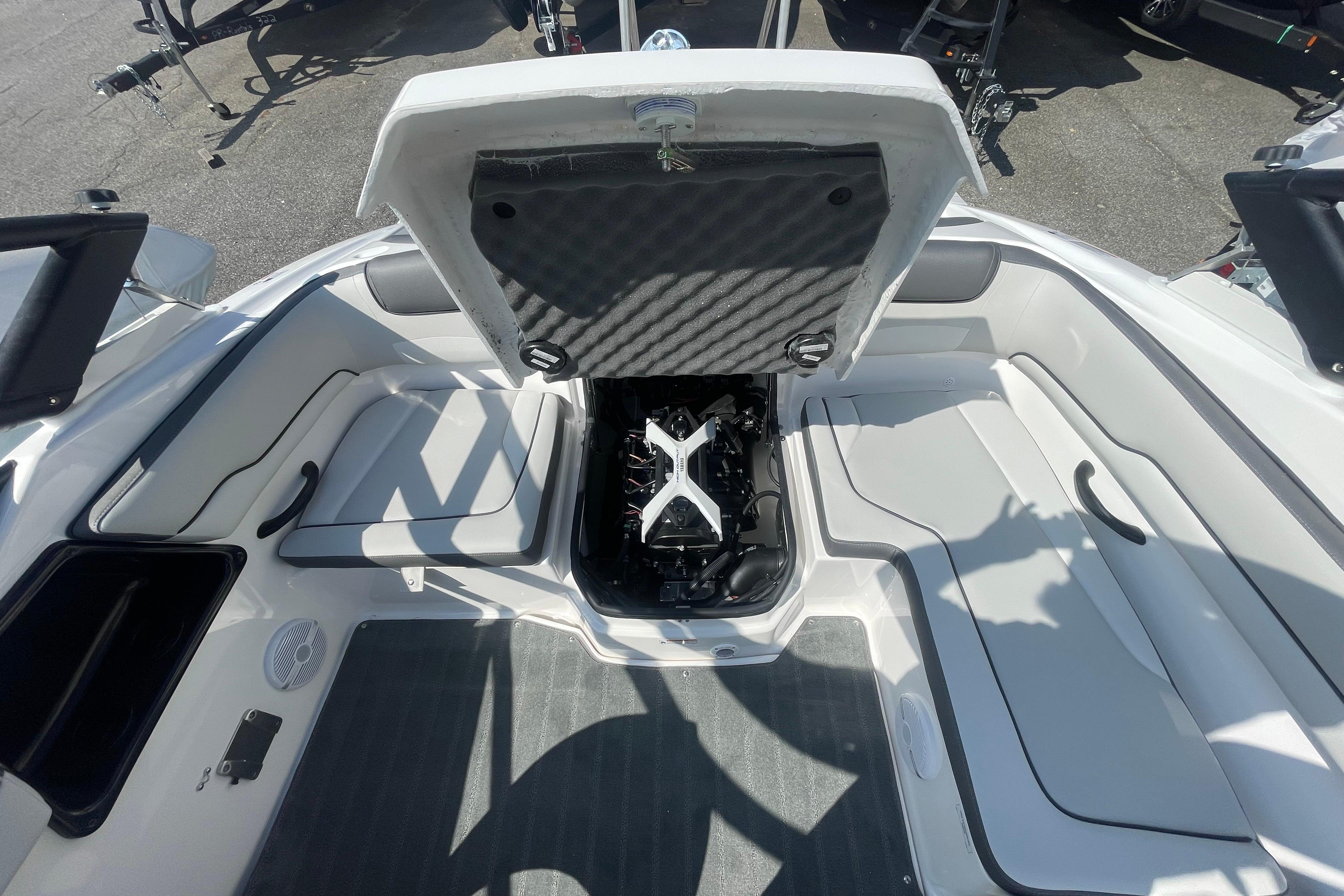 2026 Yamaha Boats AR190 engine compartment with open hatch, showcasing interior seating and design.