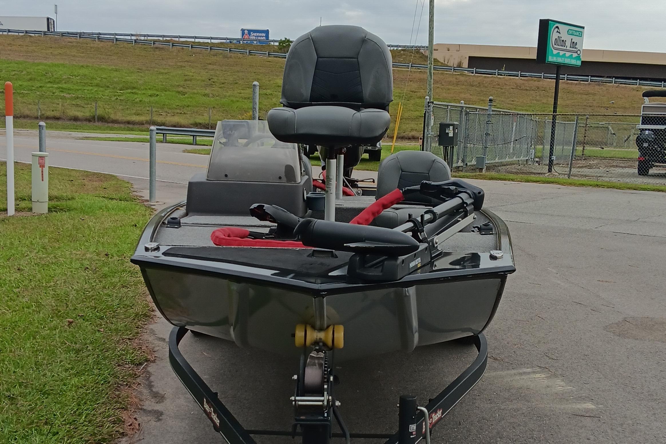 2023 Tracker Bass Tracker Classic XL boat on trailer, parked near road and grassy area.