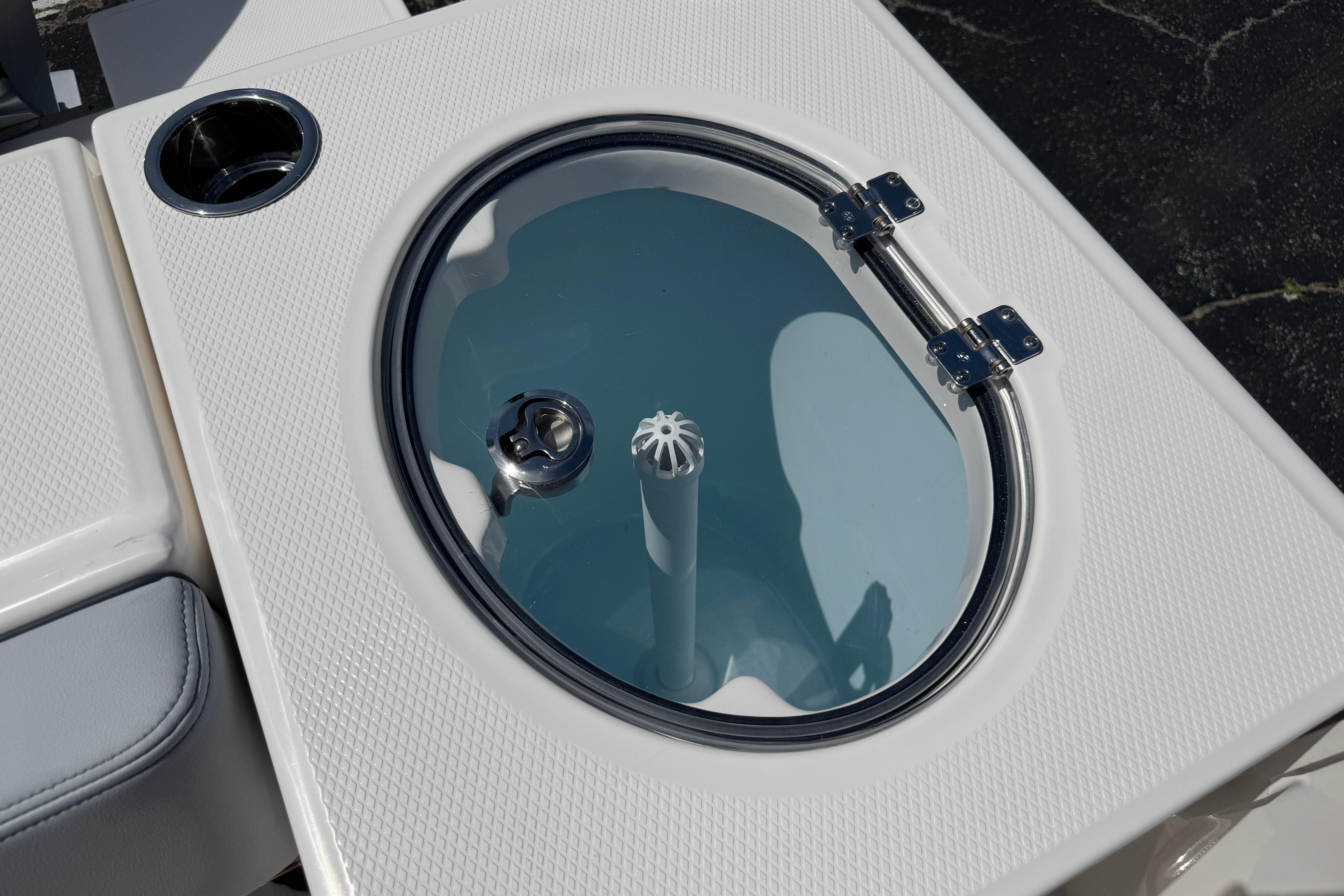 Livewell on 2026 Robalo R250 Center Console boat, featuring a sleek design and stainless steel hinges.