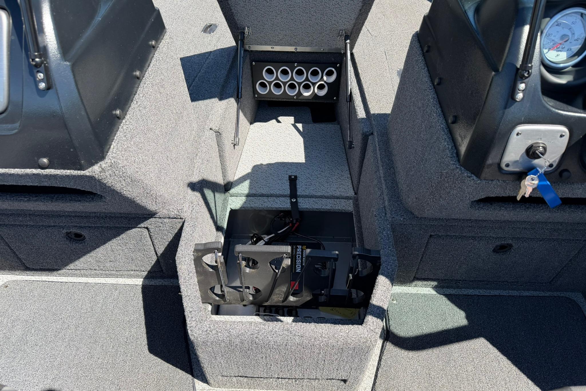 2024 Lund 1875 Impact XS Sport boat interior with storage compartments and control panel.