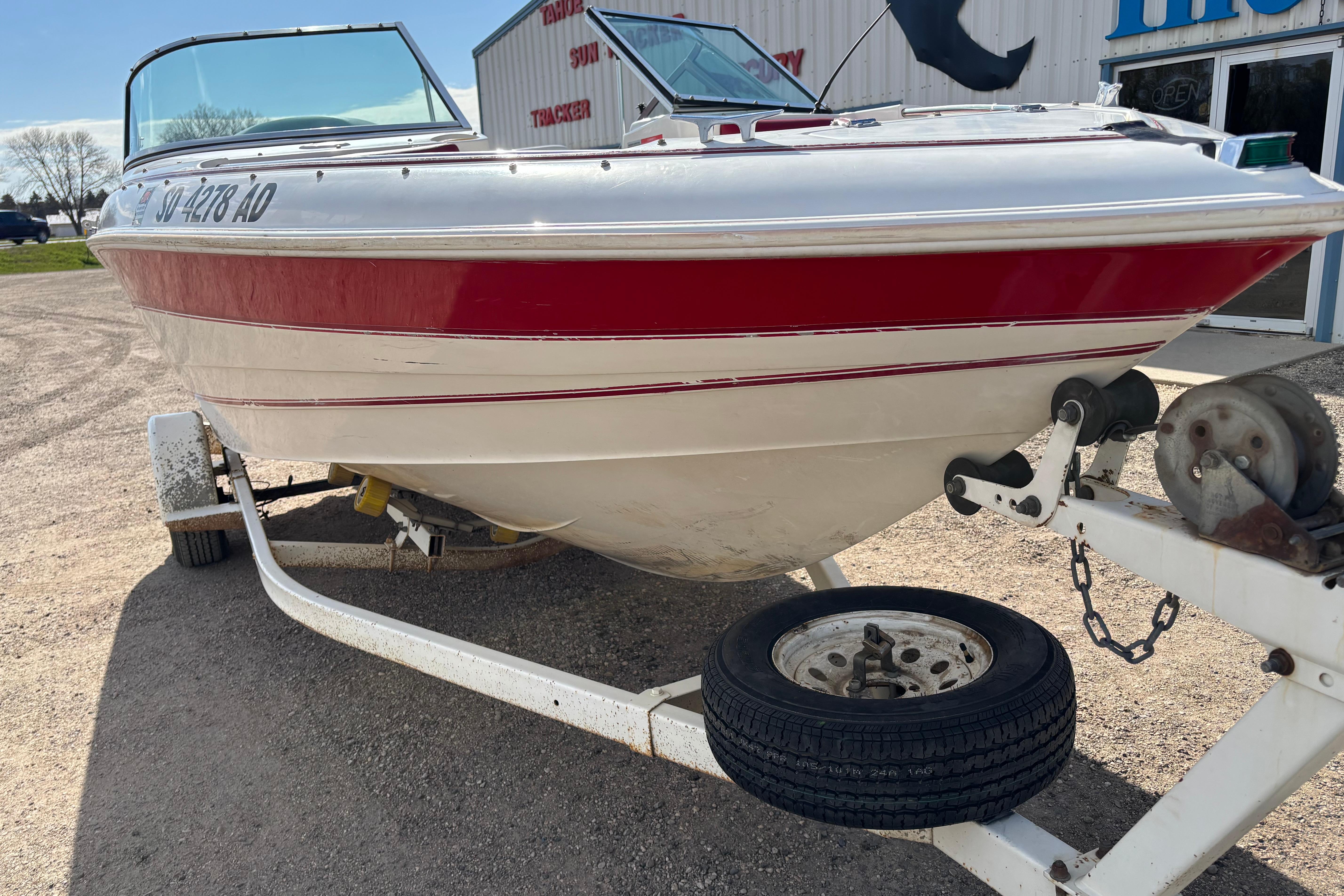 1993 Larson SEi 200 Cuddy I/O boat on trailer, red and white exterior.