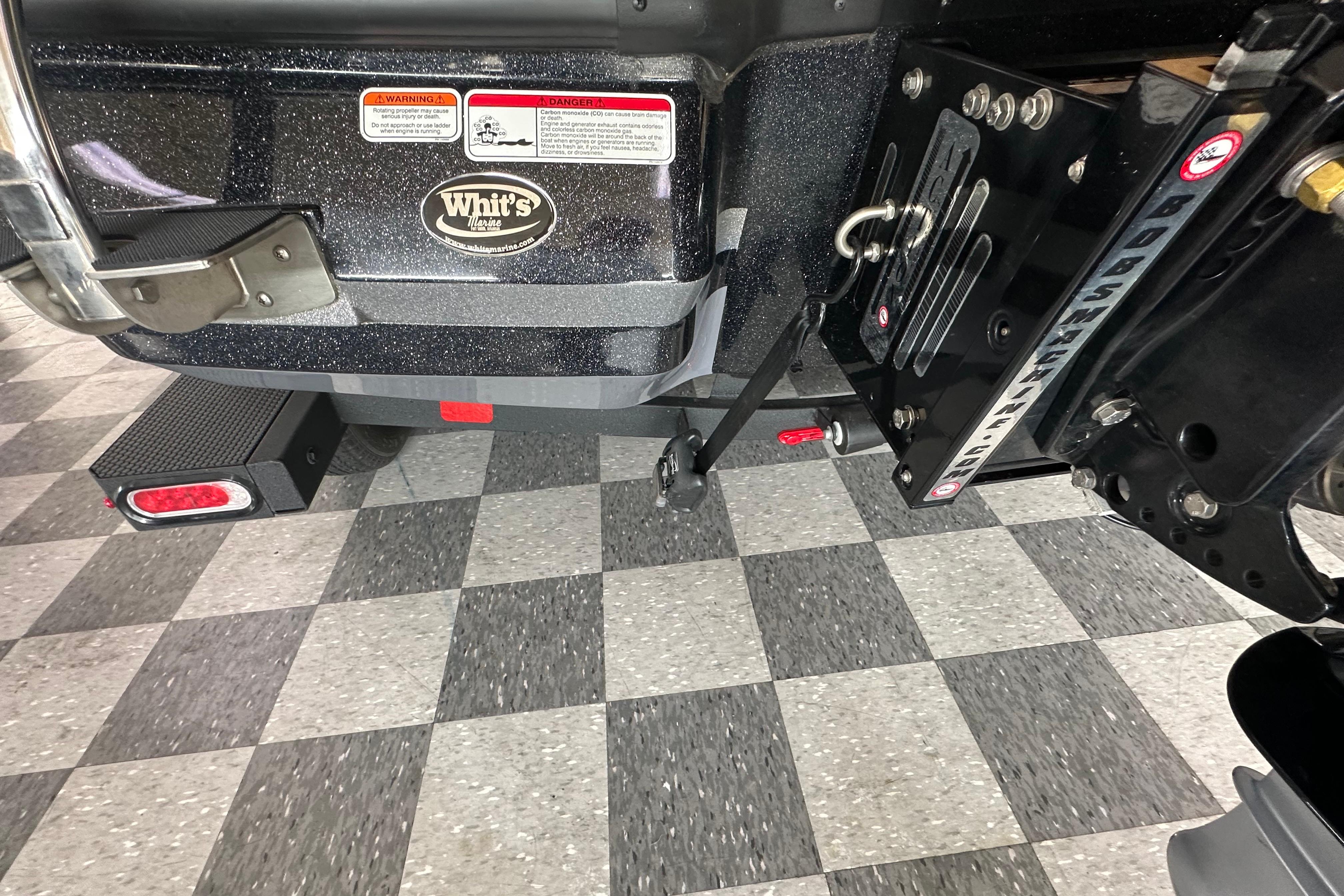 Rear view of a 2025 Nitro Z20 XL Pro boat on checkered flooring.