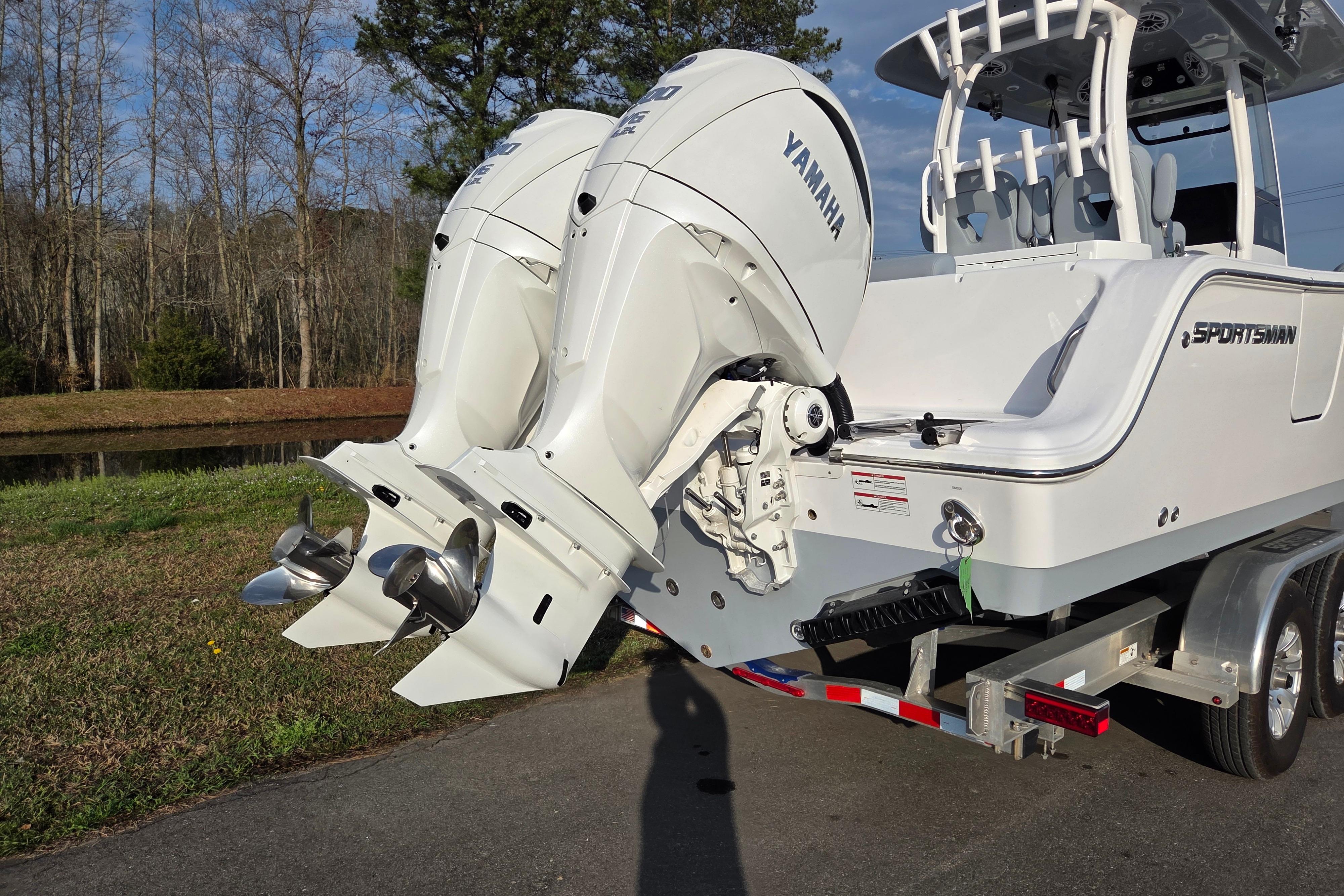2026 Sportsman Open 282 Center Console boat with dual Yamaha outboard engines on a trailer.