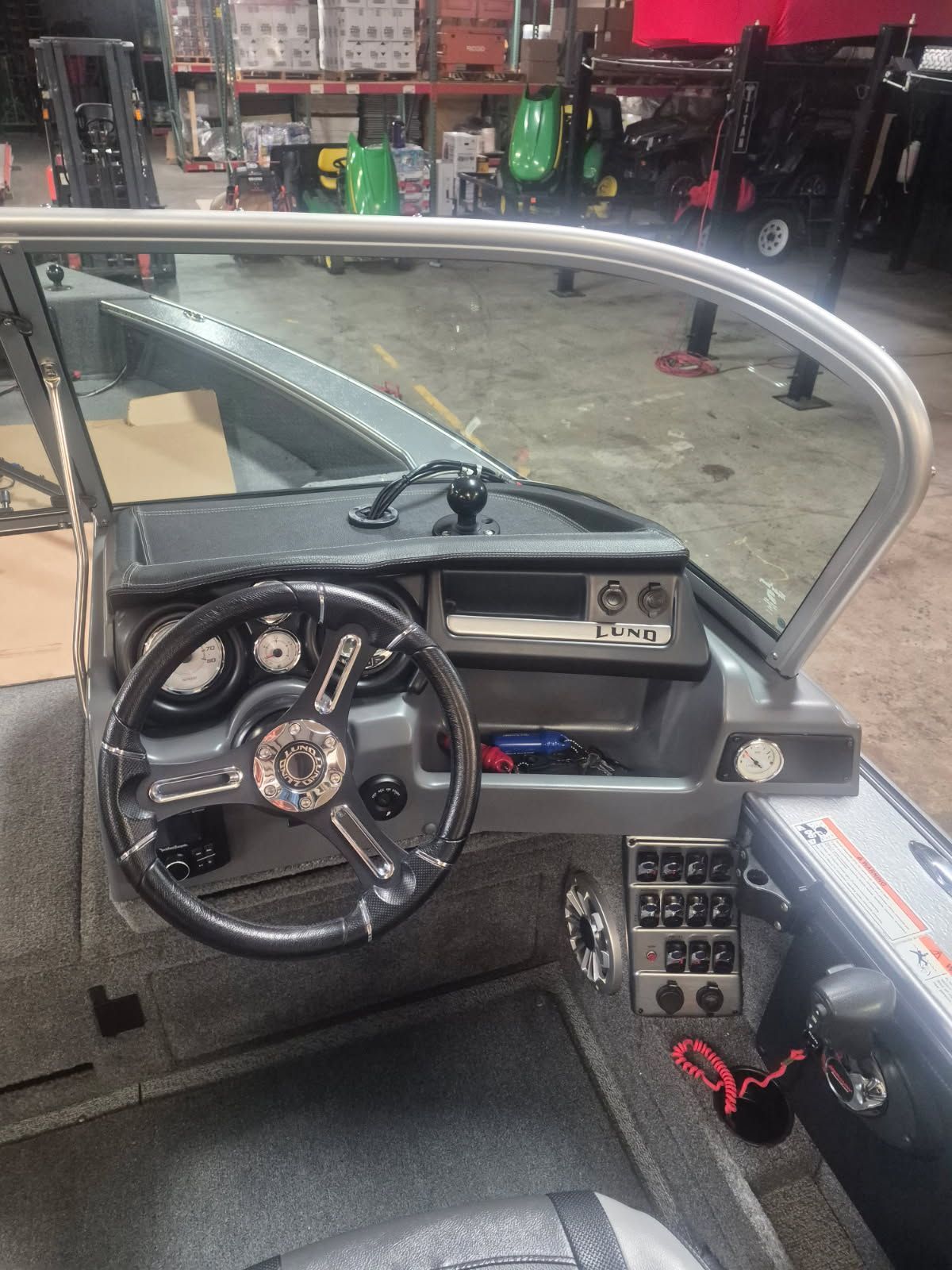 The image shows the cockpit of a 2017 Lund Pro-V 2075 boat with a modern helm.