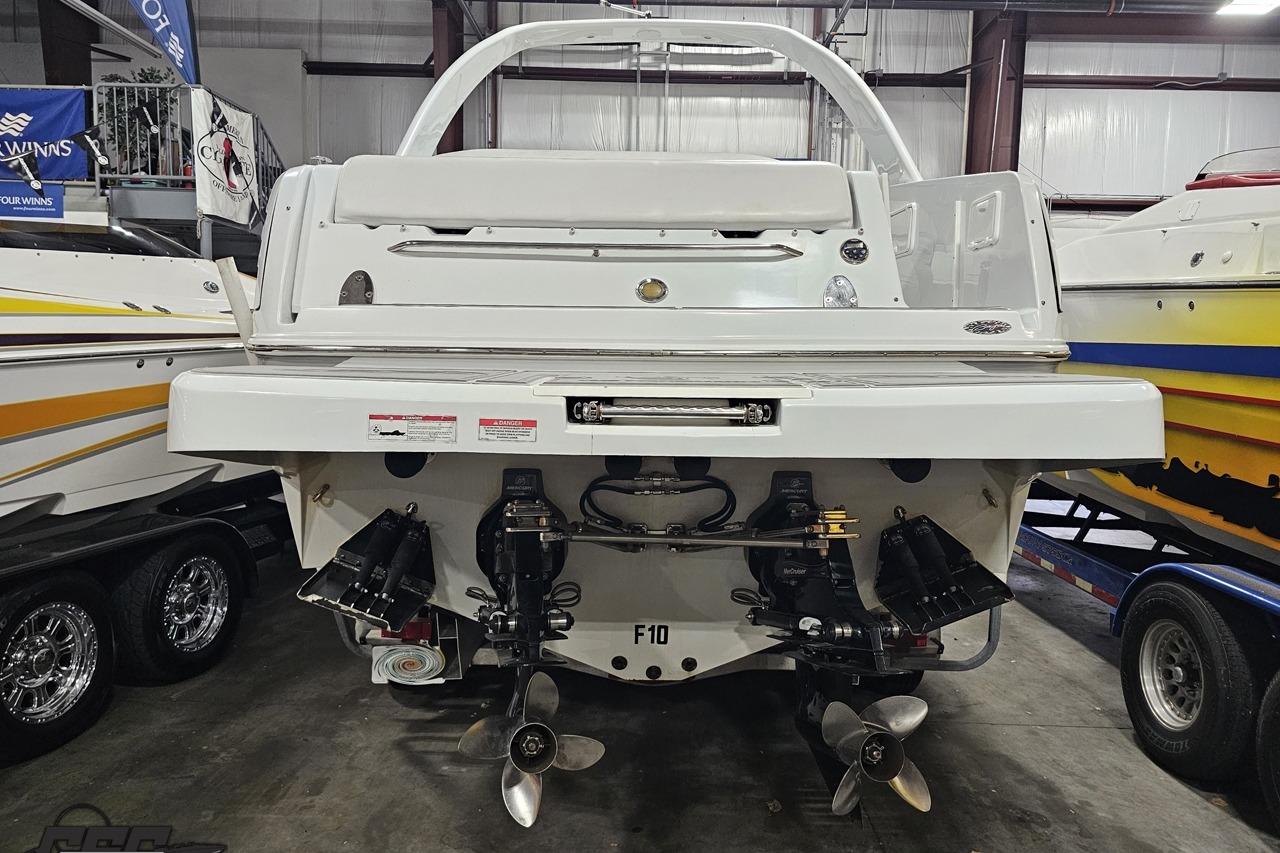 2008 Baja 335 Performance boat in showroom, rear view with dual propellers.
