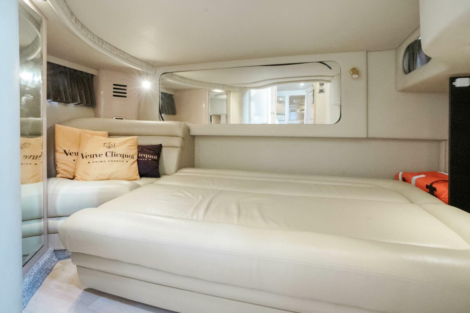 Luxurious interior cabin of 2003 Sea Ray Sundancer 460 yacht with plush bedding.