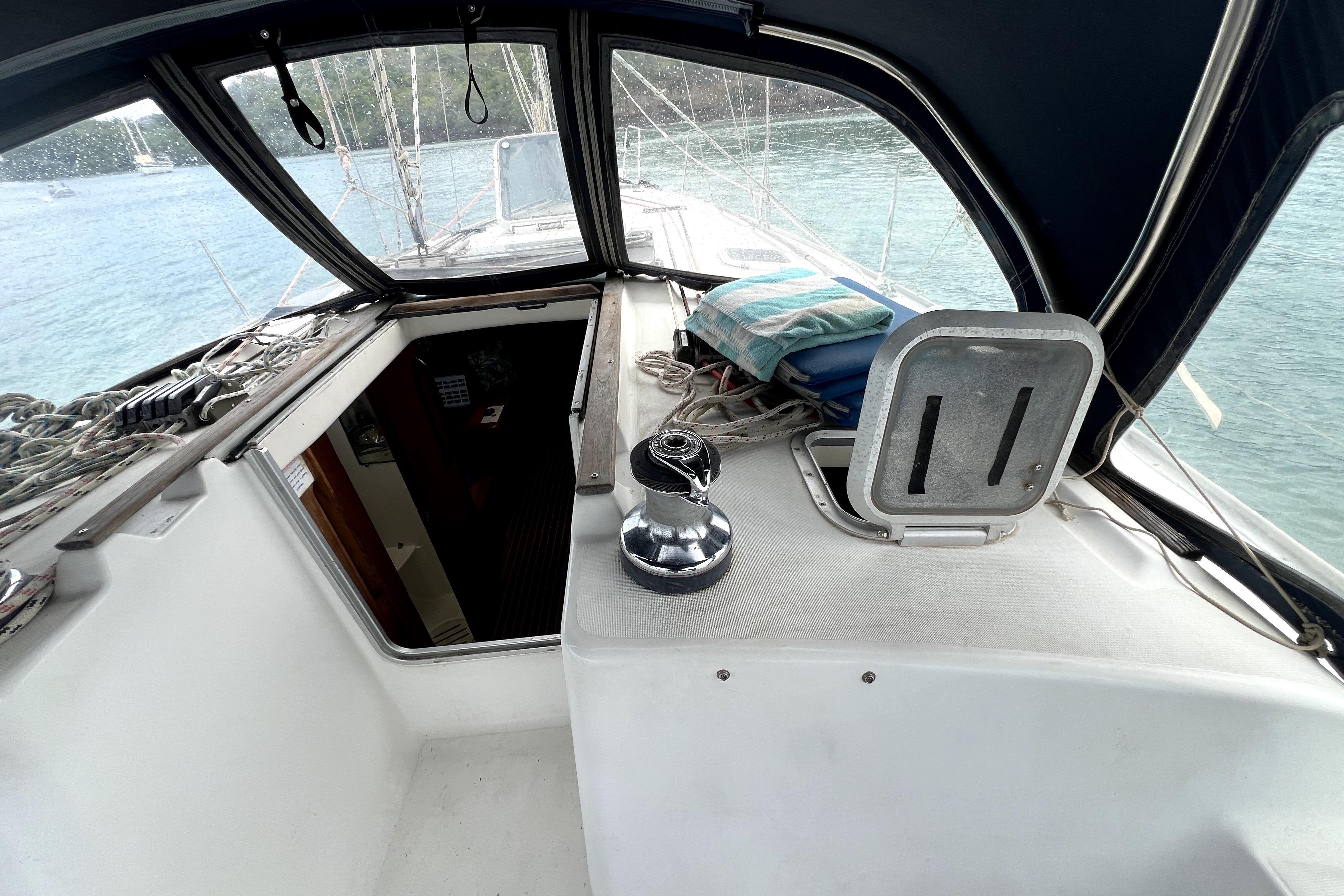 Cockpit view of 2002 Jeanneau Sun Odyssey 40 sailboat with open hatch and winch.