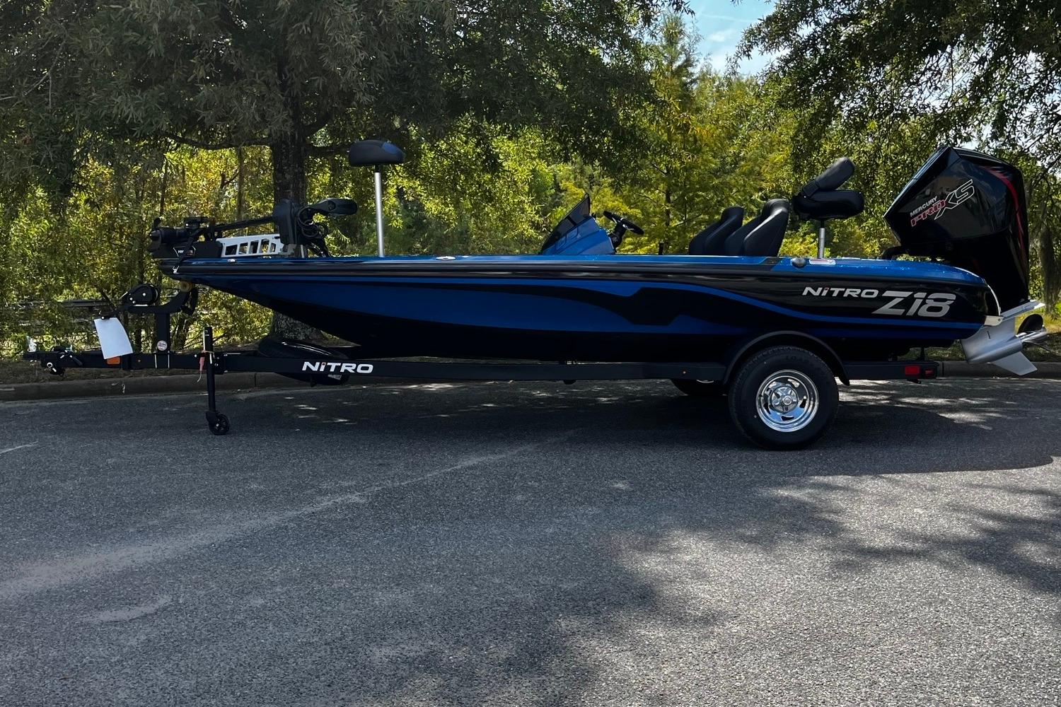 2025 Nitro Z18 boat parked on a trailer in a shaded area.