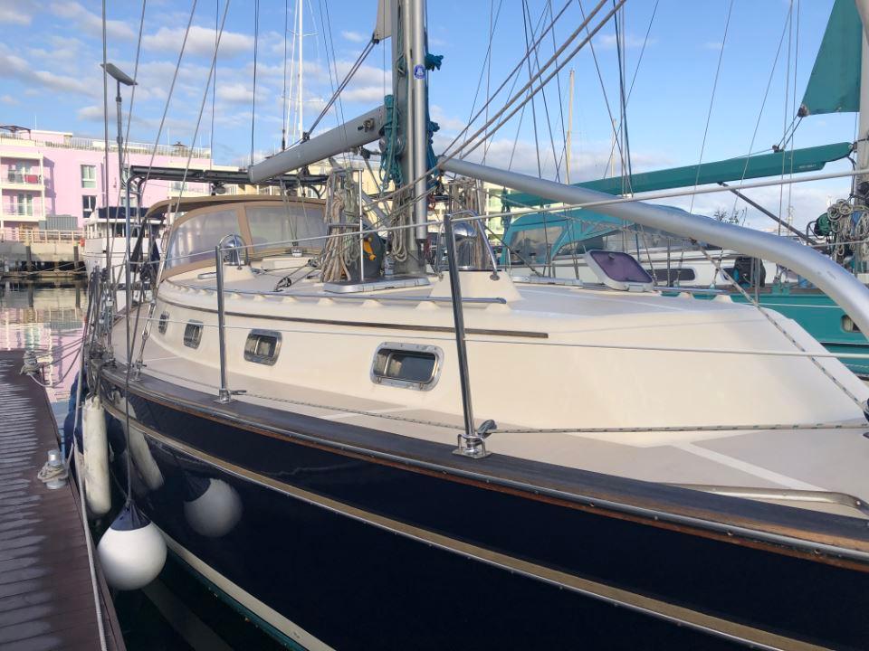 2005 Island Packet 440 sailboat docked at marina, featuring sleek design and sturdy build.